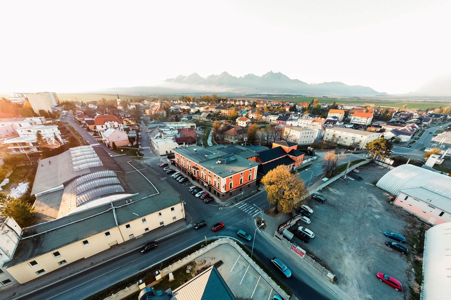 Aerial panoramic view of urban area with buildings and streets from helicopter perspective.