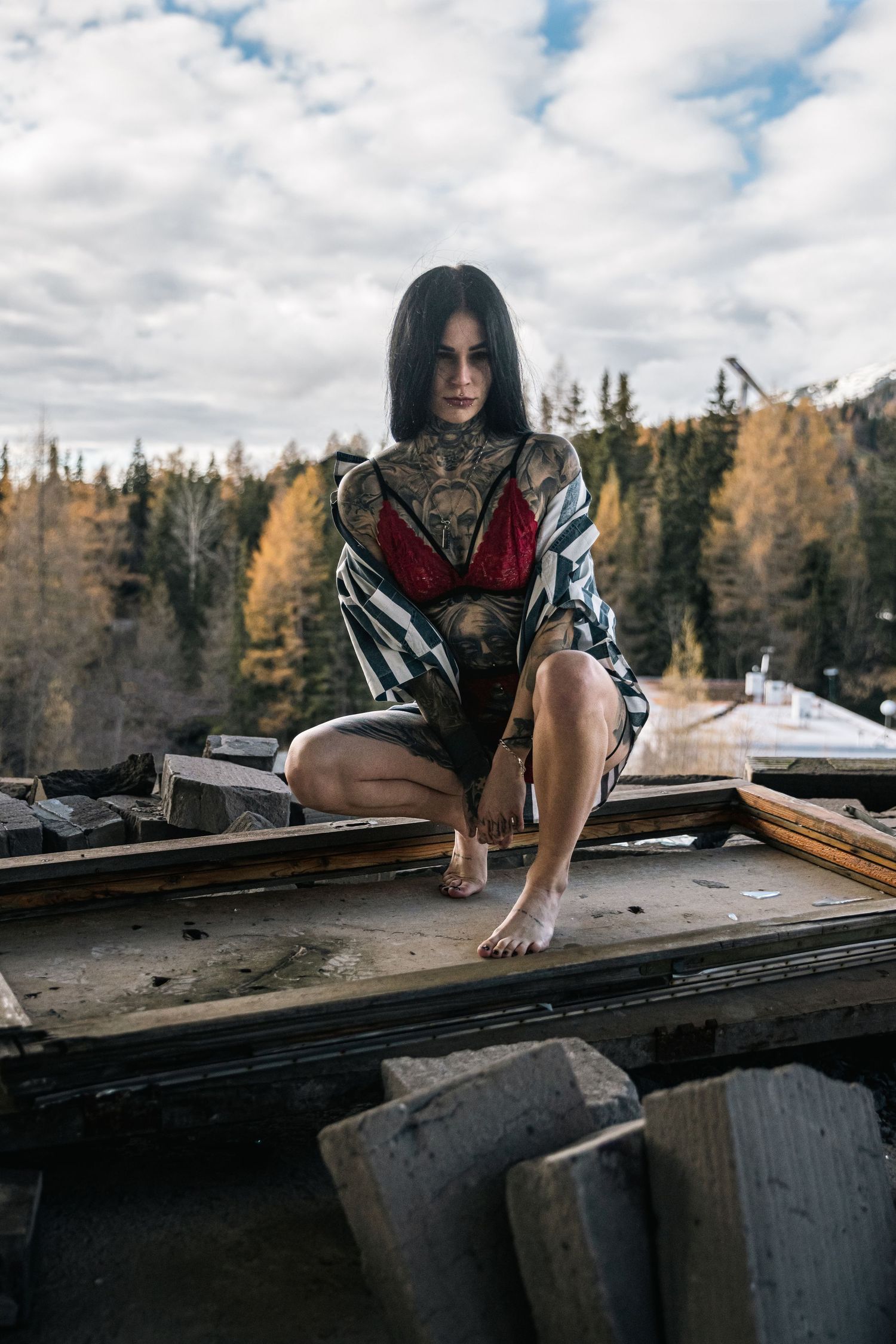 Artistic shots on a rooftop edge with mountain forest scenery in the background.