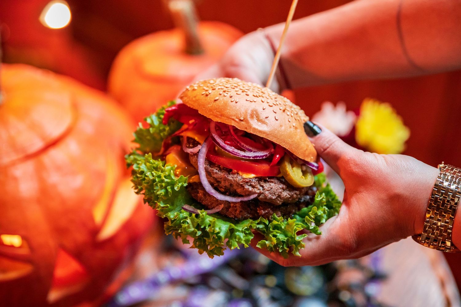 Close-up shots of gourmet burgers with fresh toppings and garnishes on serving plates.