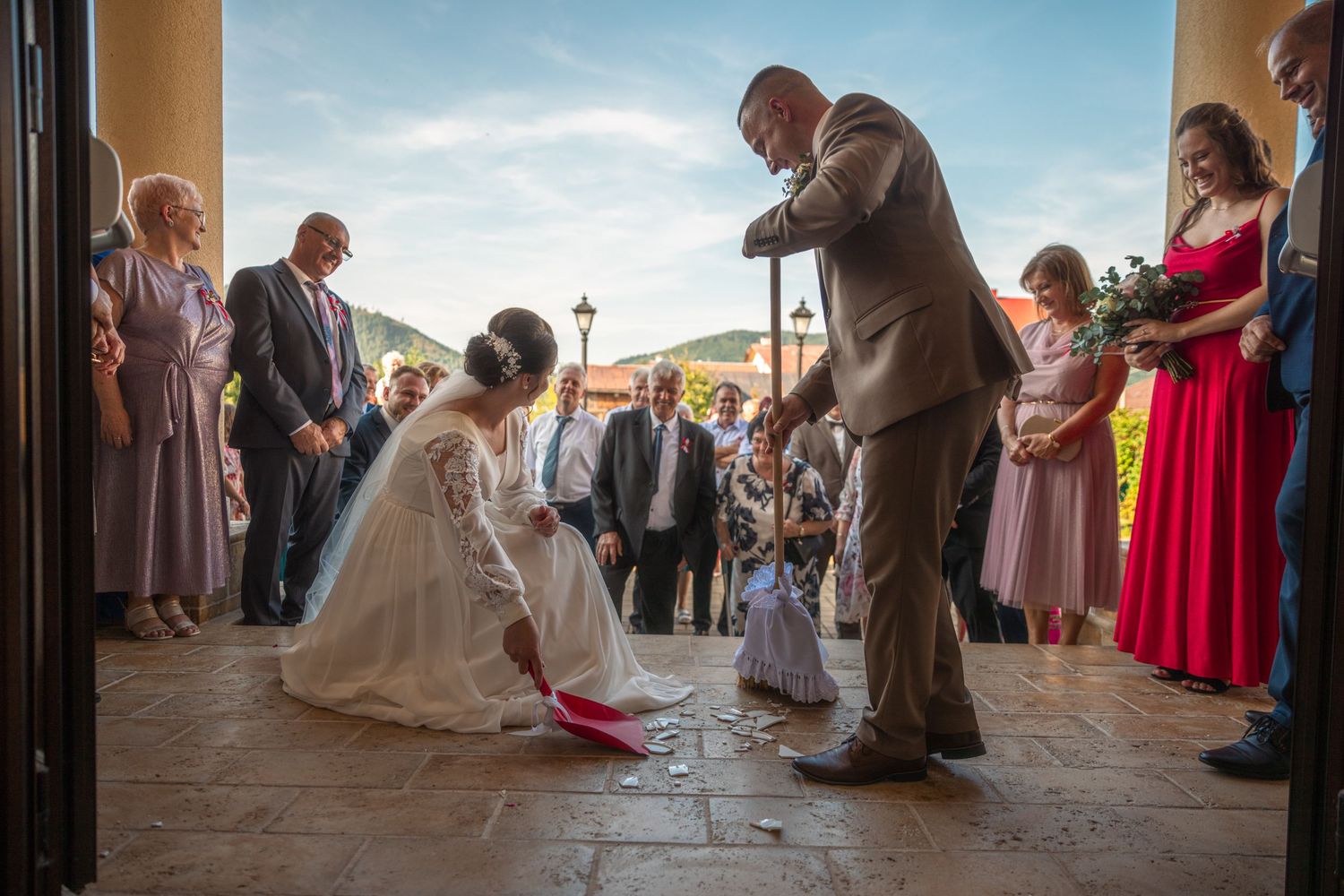 Wedding ceremony guests seated in rows during an outdoor sunset celebration.