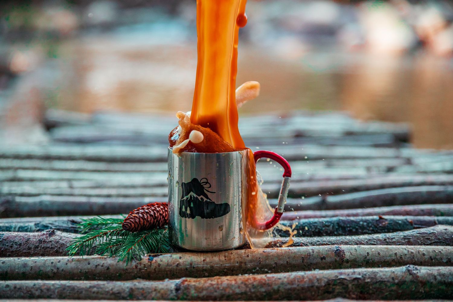 Close-up sequence of pouring coffee from orange carafe onto metal grating.