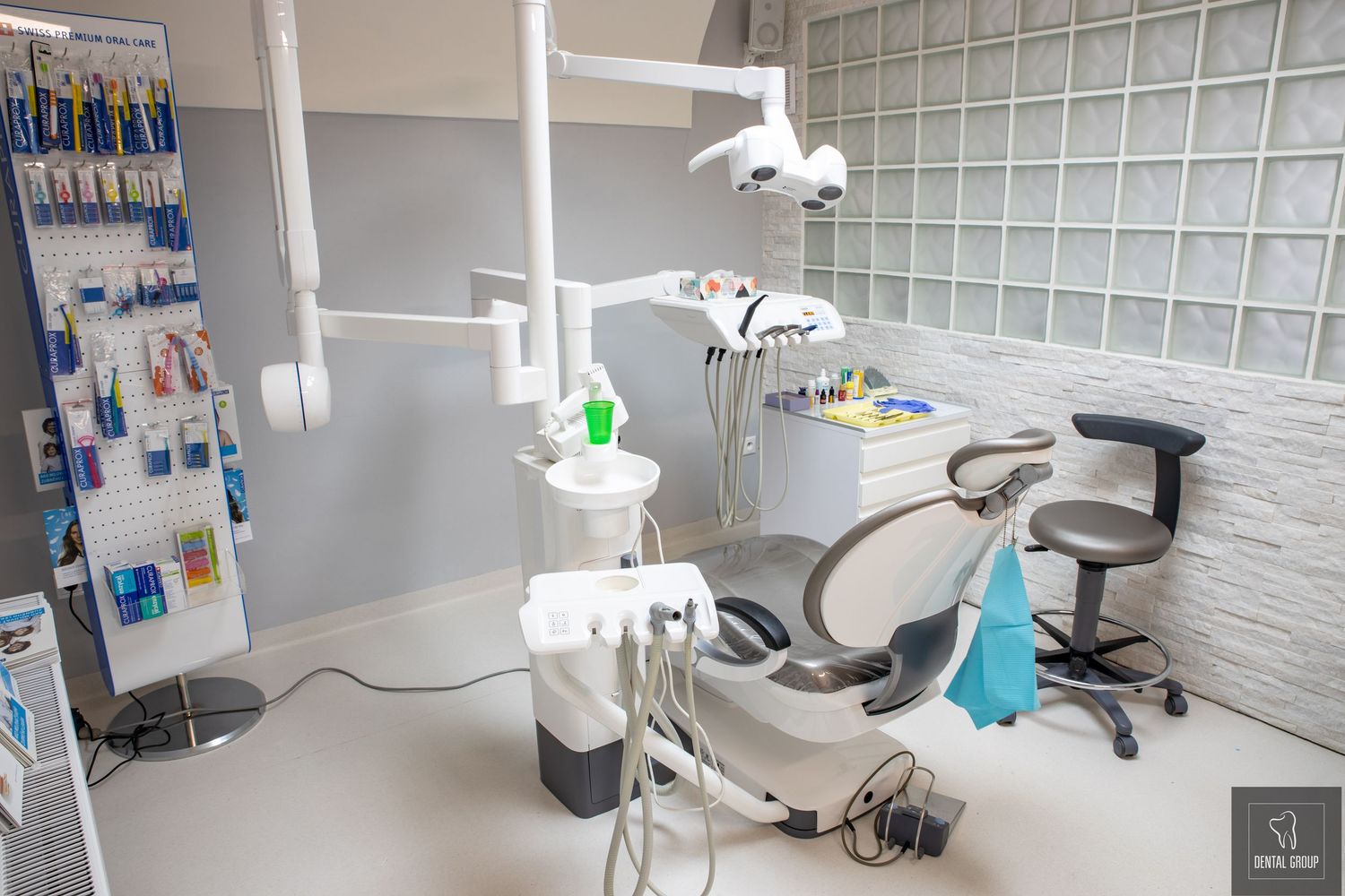 Dental operatory room featuring advanced medical equipment and ergonomic furniture in bright setting.