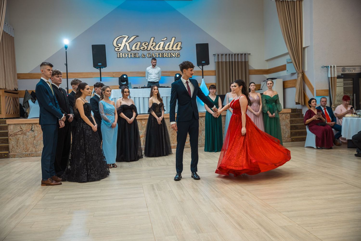 Elegant ballroom dance performance with formal attire in a spacious venue.