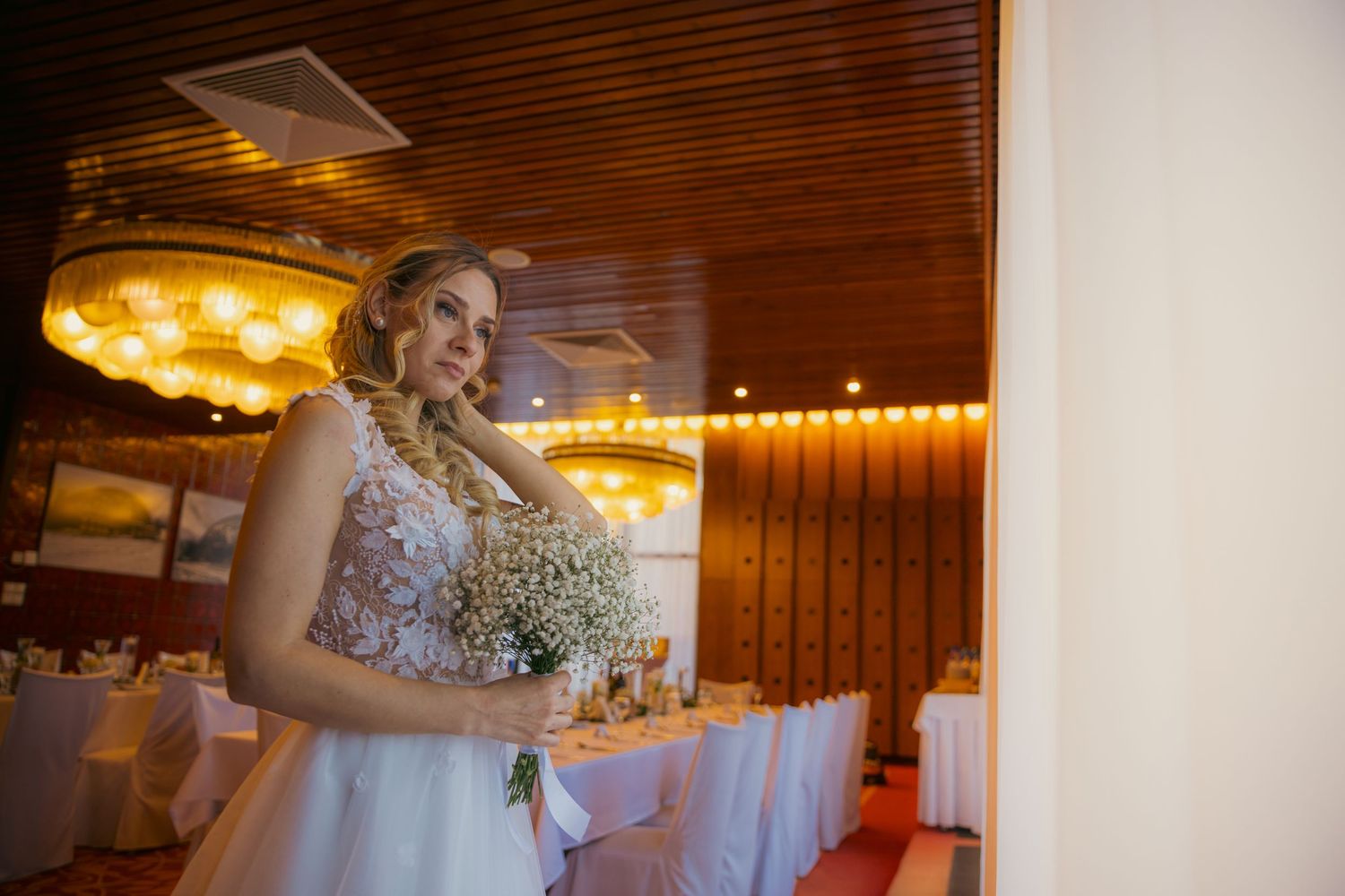 Elegant wedding reception venue with warm lighting and rustic wooden interior.
