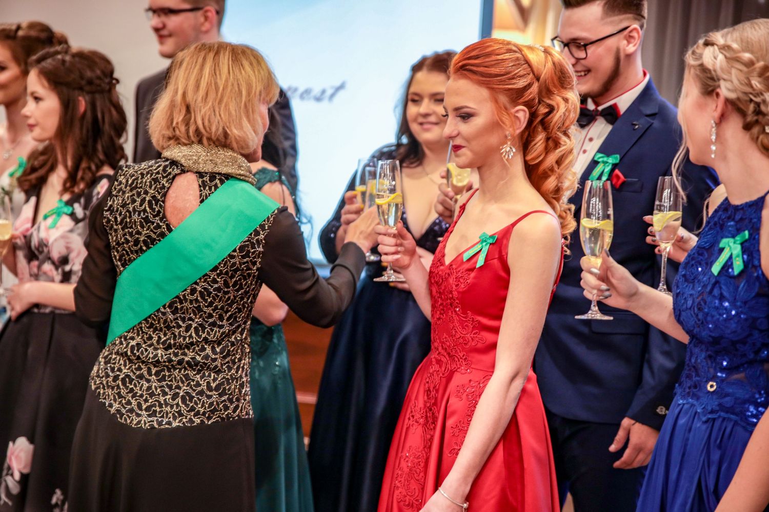 Guests in colorful formal attire mingling at an elegant evening event.