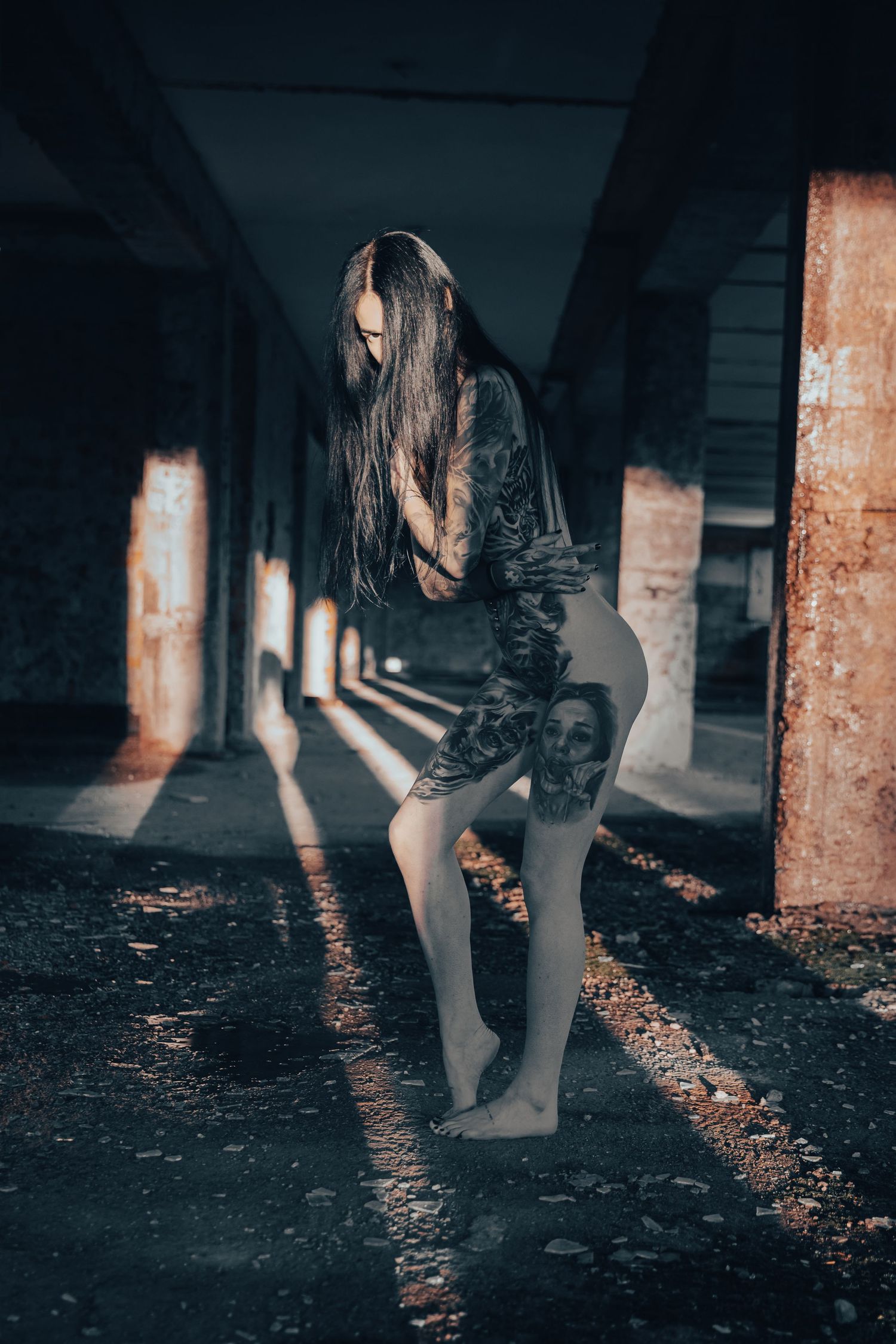 Moody low-light photography in a dark abandoned space with dramatic shadows.