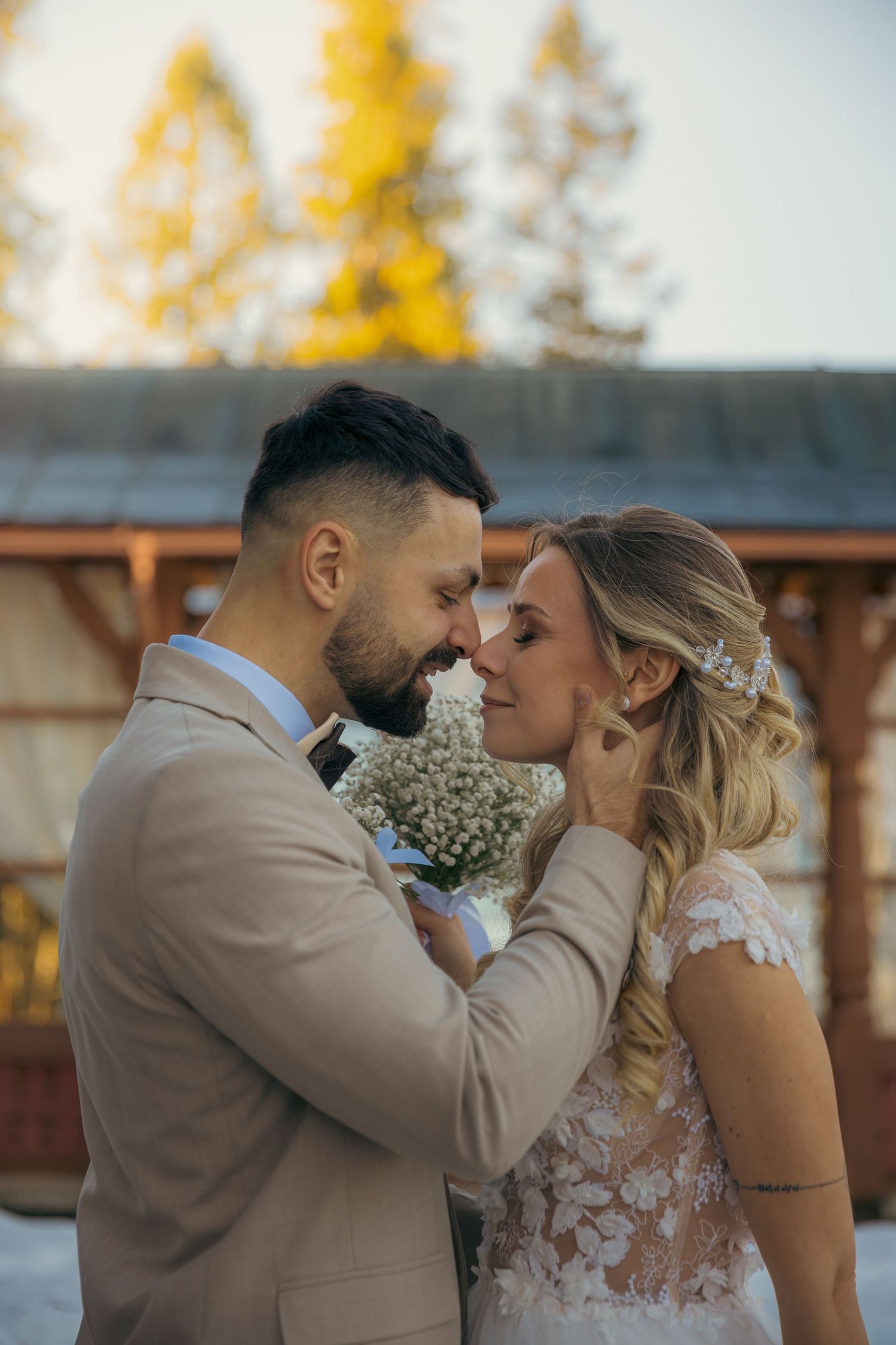 Intimate wedding couple shares romantic moment during golden hour.