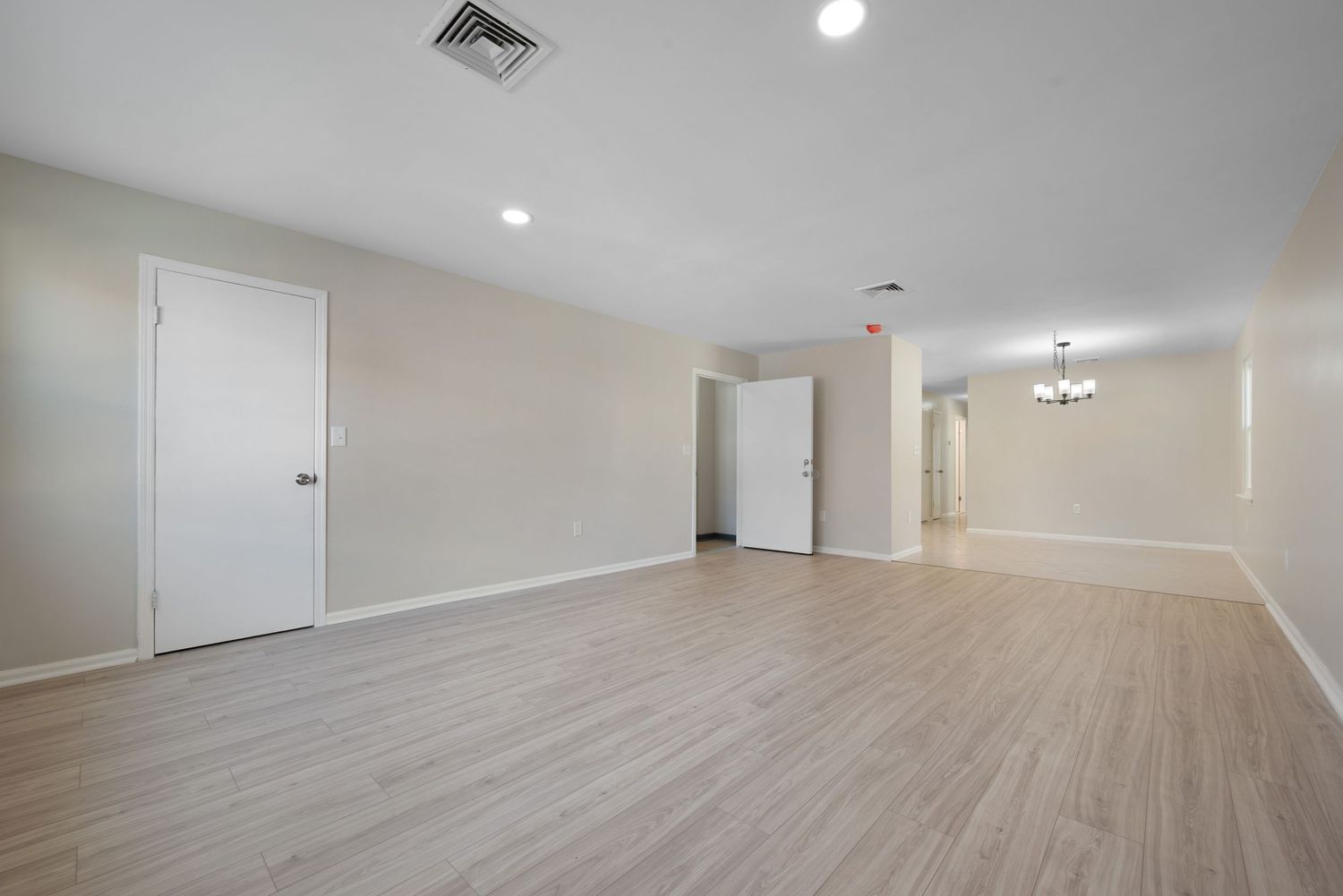 Large living room showing connection to dining room and front door.