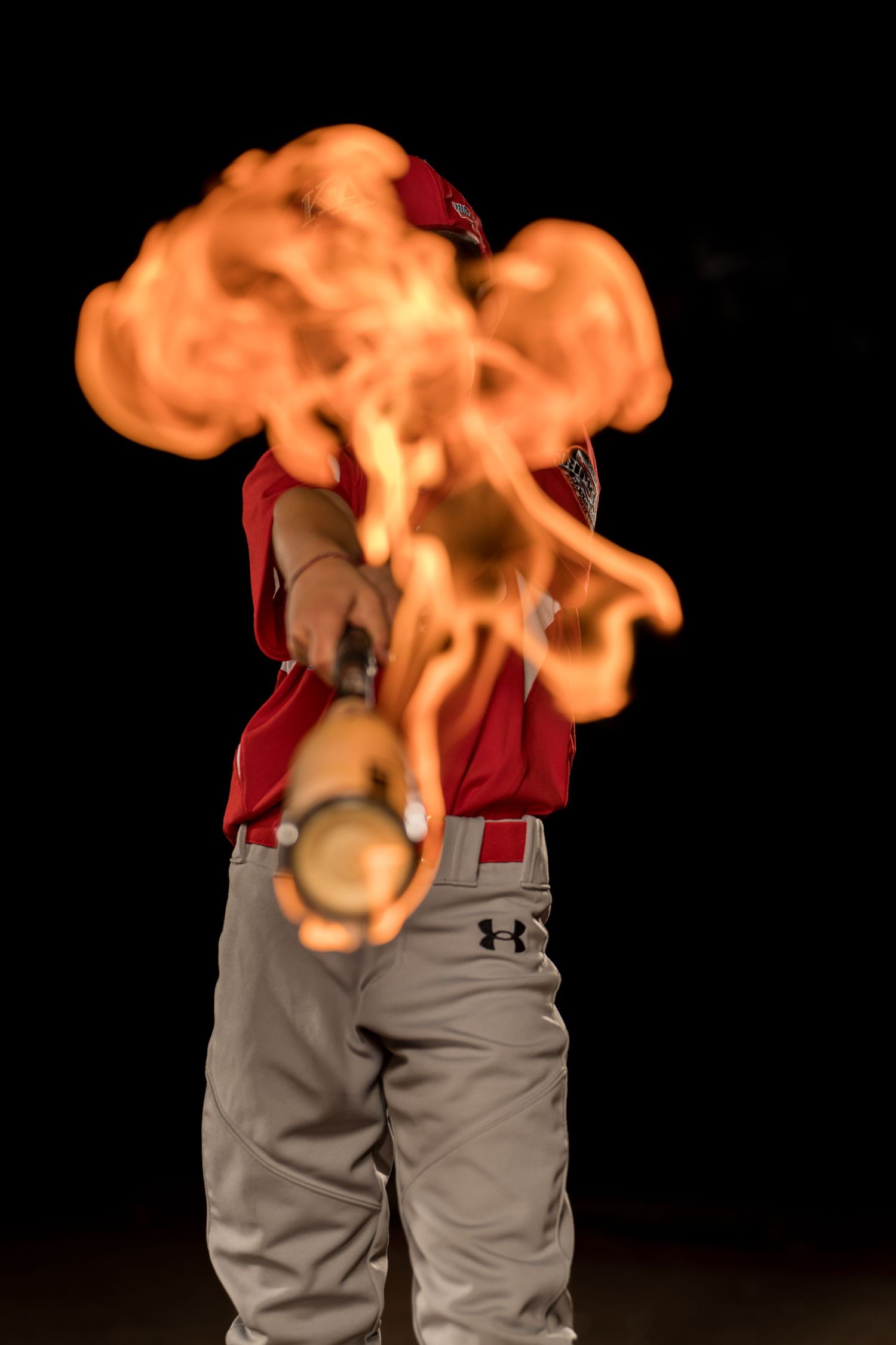 Baseball Media Day photo with flaming bat captured by Dillon Lane Photography in Tri Cities WA showcasing bold sports creativity.
