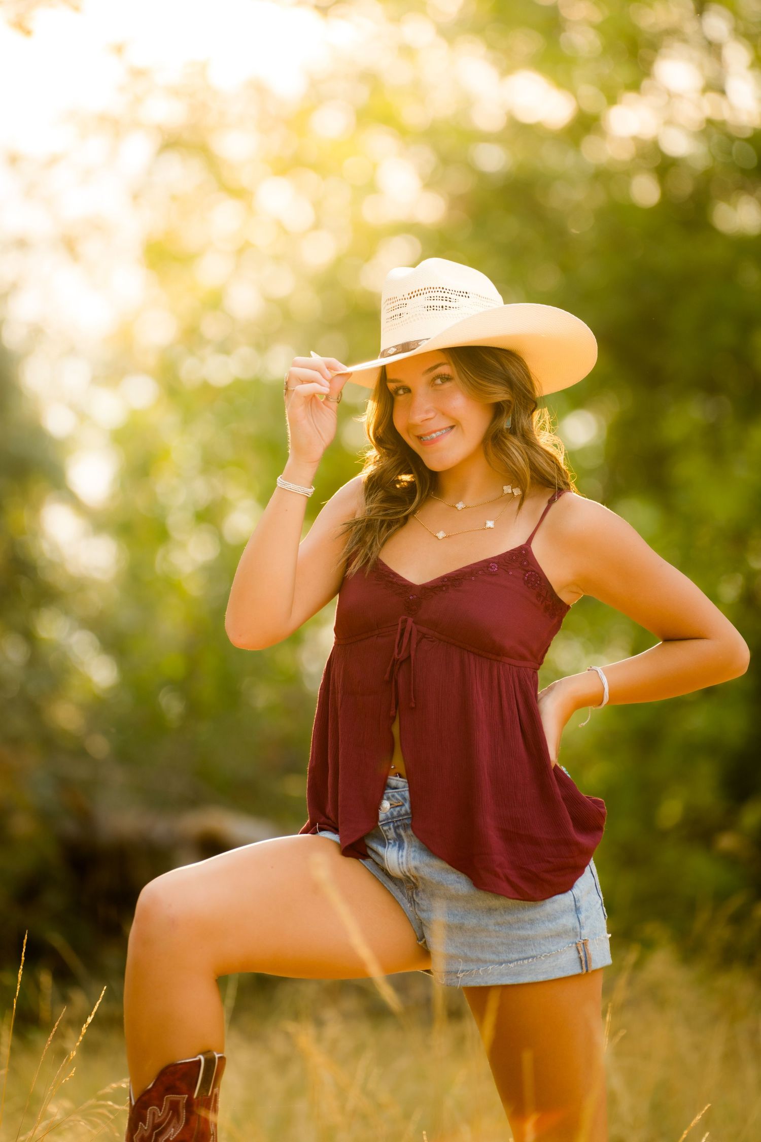 Country girl senior portrait in Eastern Washington captured by Dillon Lane Photography with warm golden light and natural rustic style.