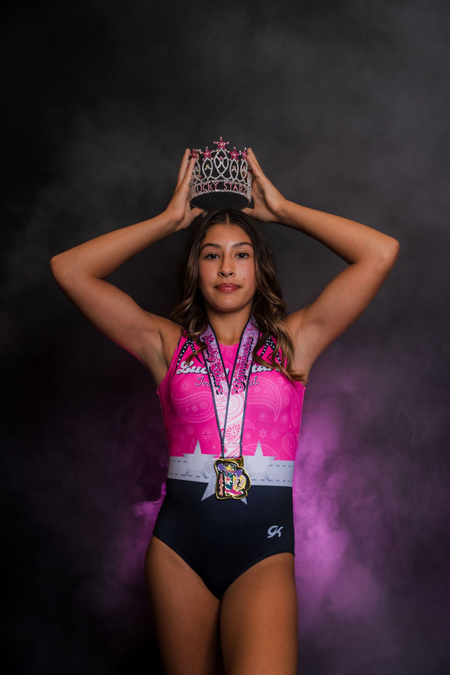 Artistic portrait series with pink smoke effects and a sparkling tiara.