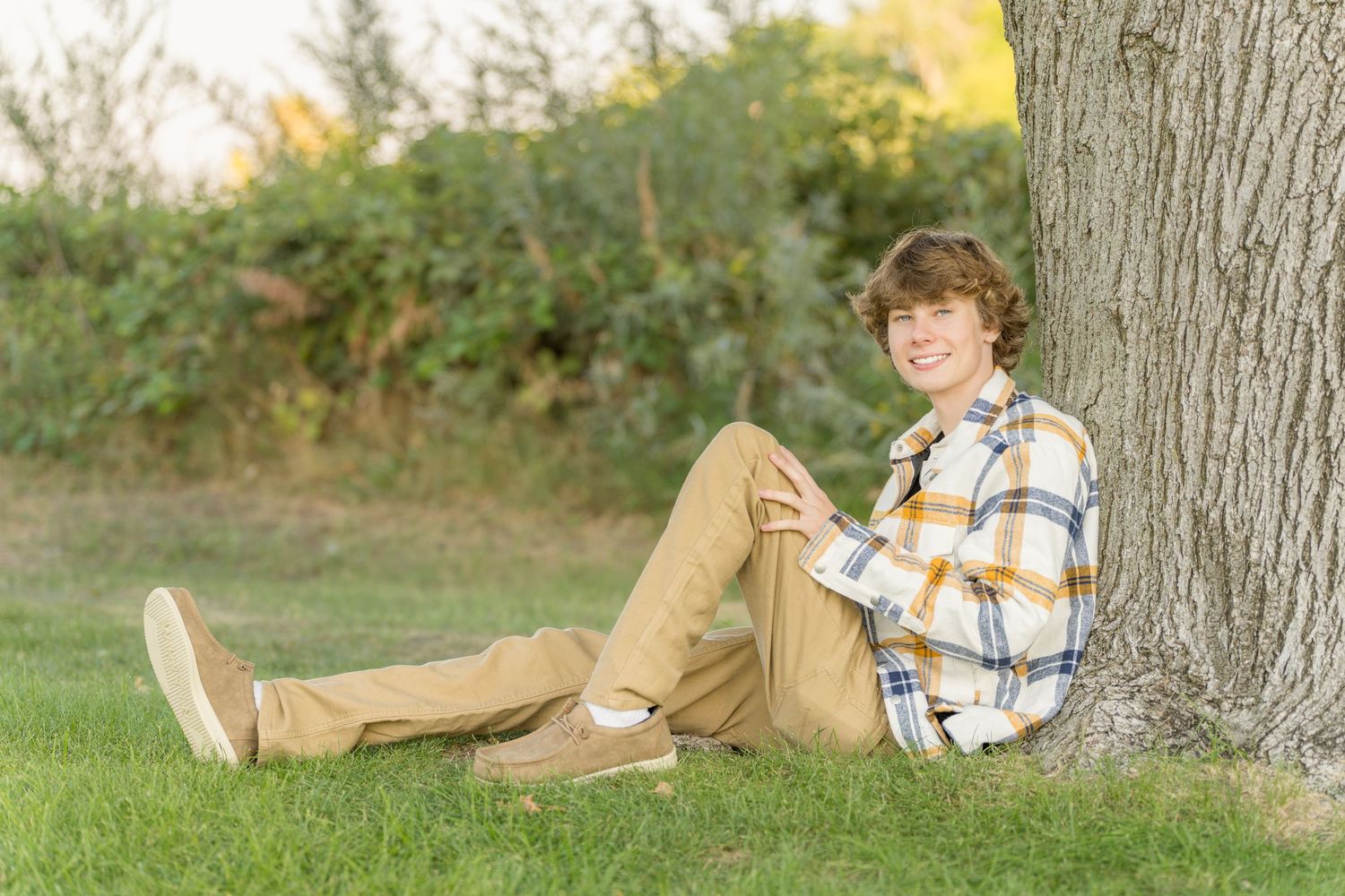 A collage of outdoor autumn portraits showing someone resting against a tree.