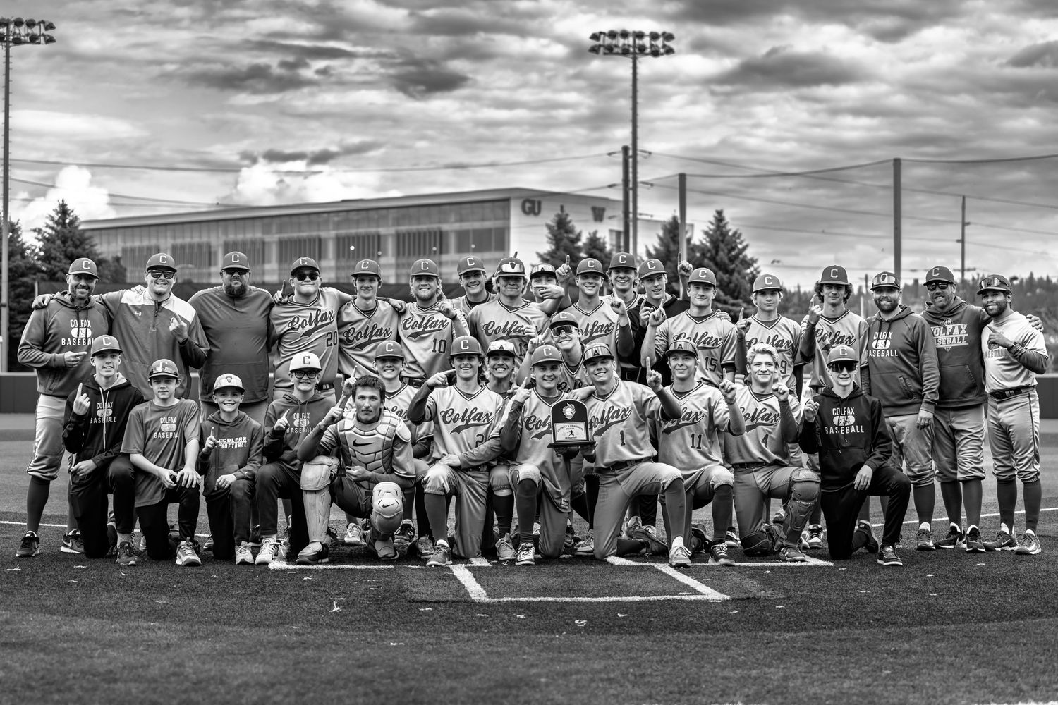 Colfax baseball team celebrating district championship captured by Dillon Lane Photography in Eastern Washington showcasing team pride.