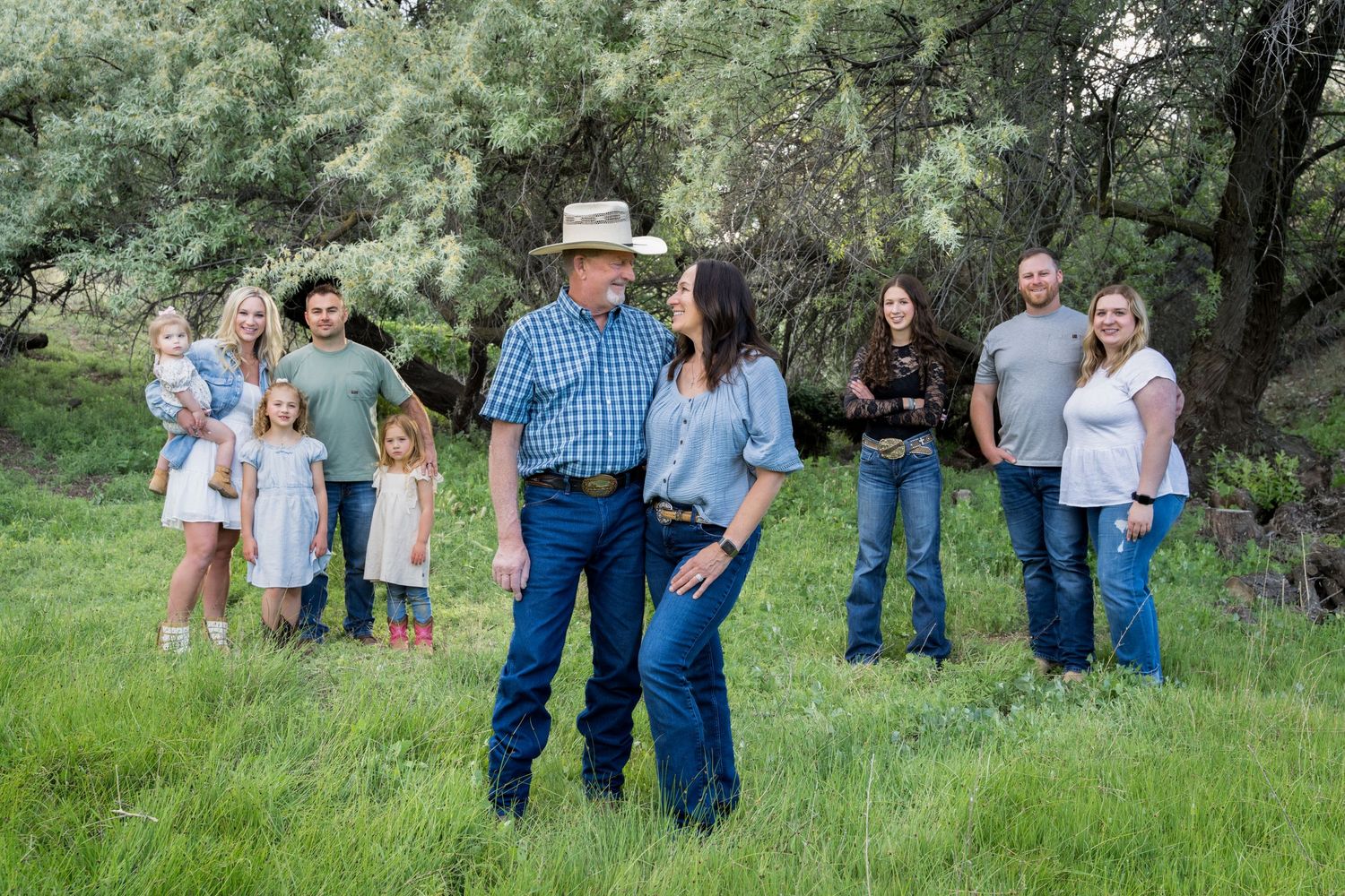 Family portrait in green field captured by Dillon Lane Photography in Tri Cities WA showcasing love, connection, and natural light.