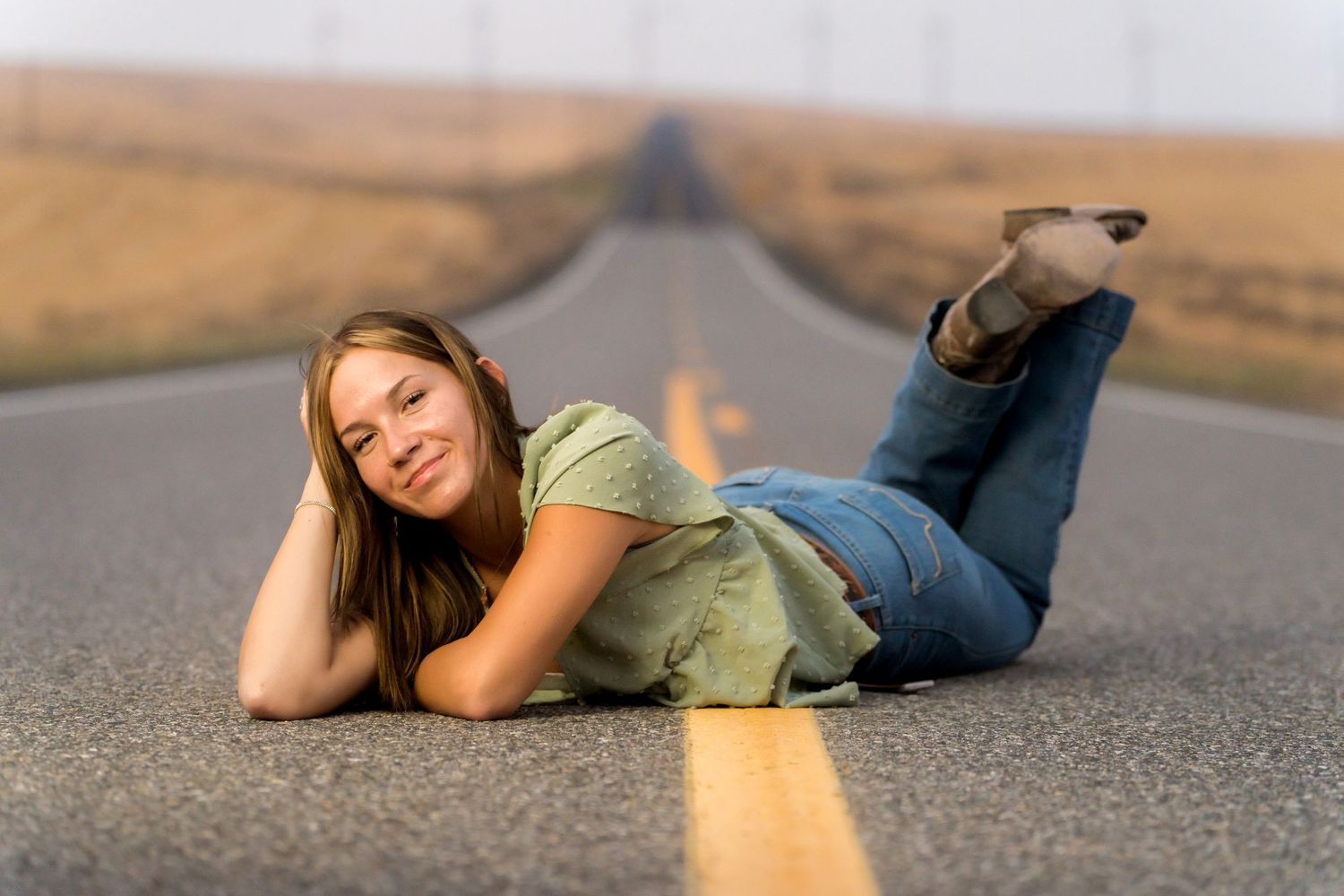 Senior girl portrait on a country road captured by Dillon Lane Photography during golden hour in Eastern Washington.