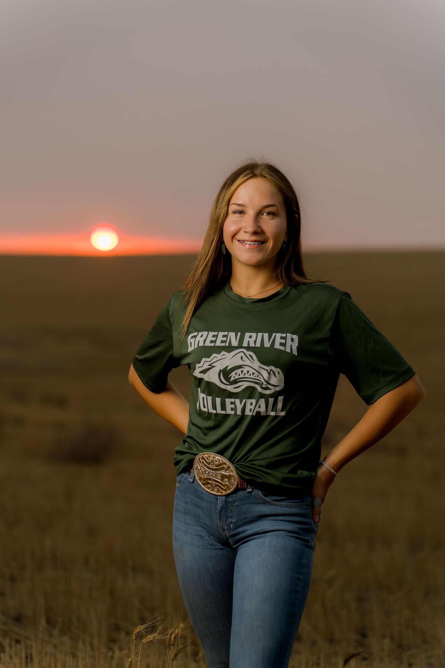 Excited senior girl announcing volleyball college commitment at sunset in Kennewick WA captured by Dillon Lane Photography.