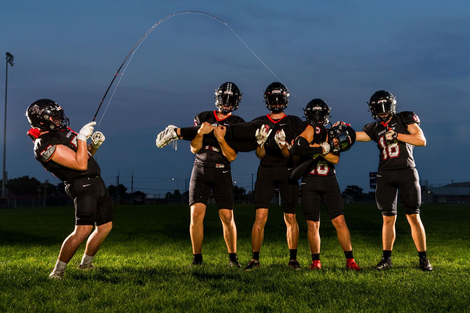 Football Media Day photo in Tri Cities WA with players fishing captured by Dillon Lane Photography showcasing team spirit and energy.