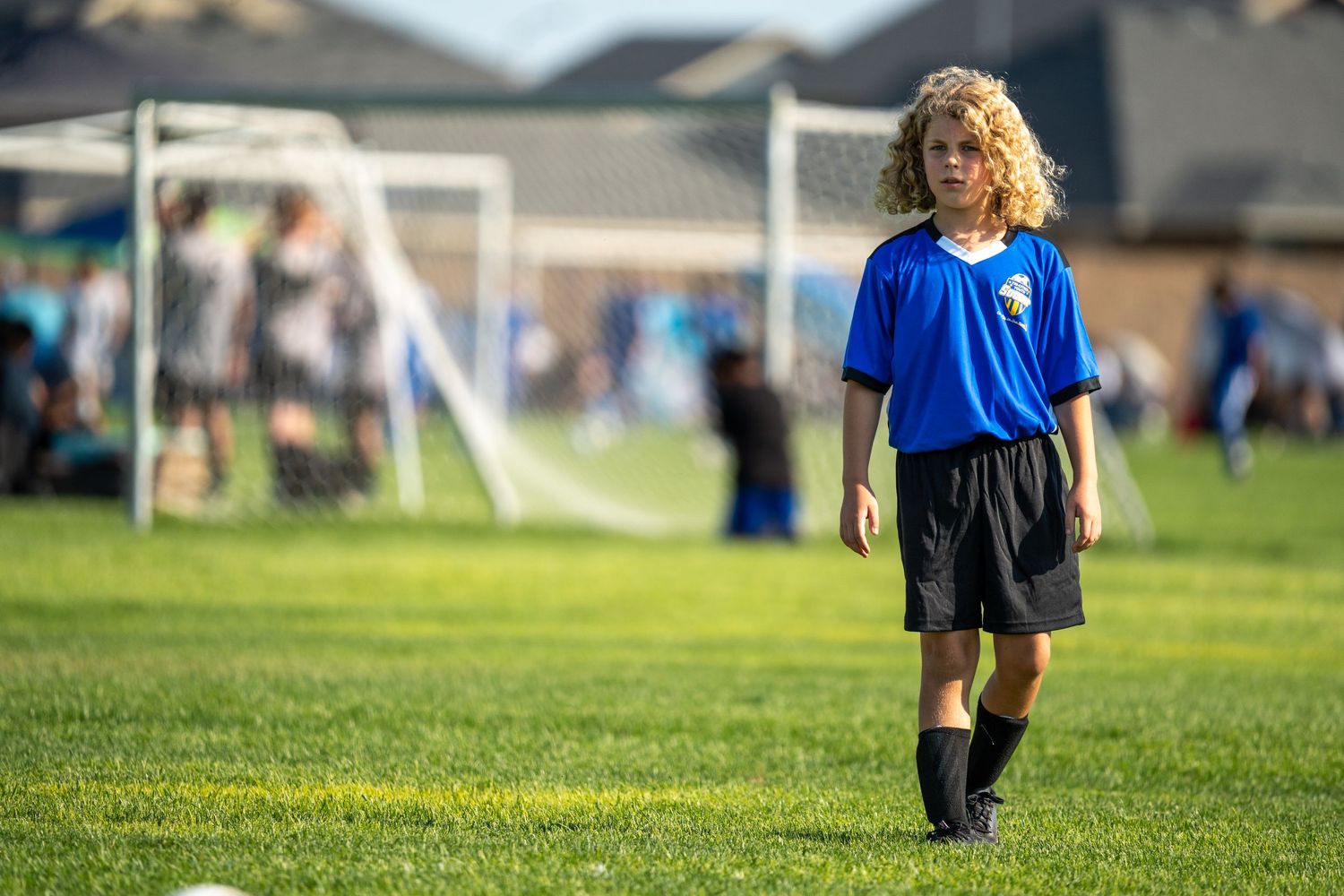 Youth soccer player on field during game captured by Dillon Lane Photography in Tri Cities WA showcasing action and athletic focus.