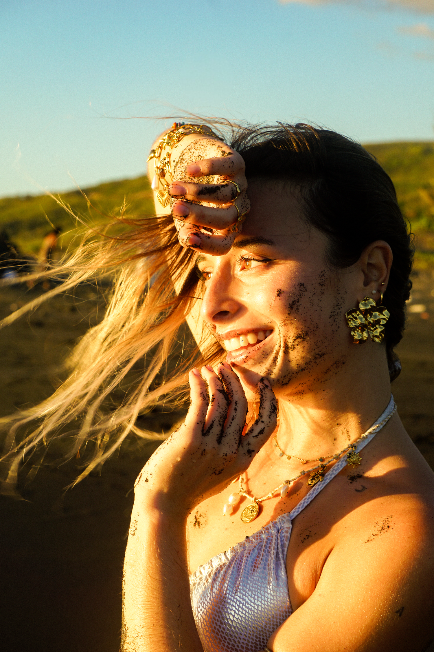 shooting photo plage avec une femme qui sourie au maillot de bain argenté