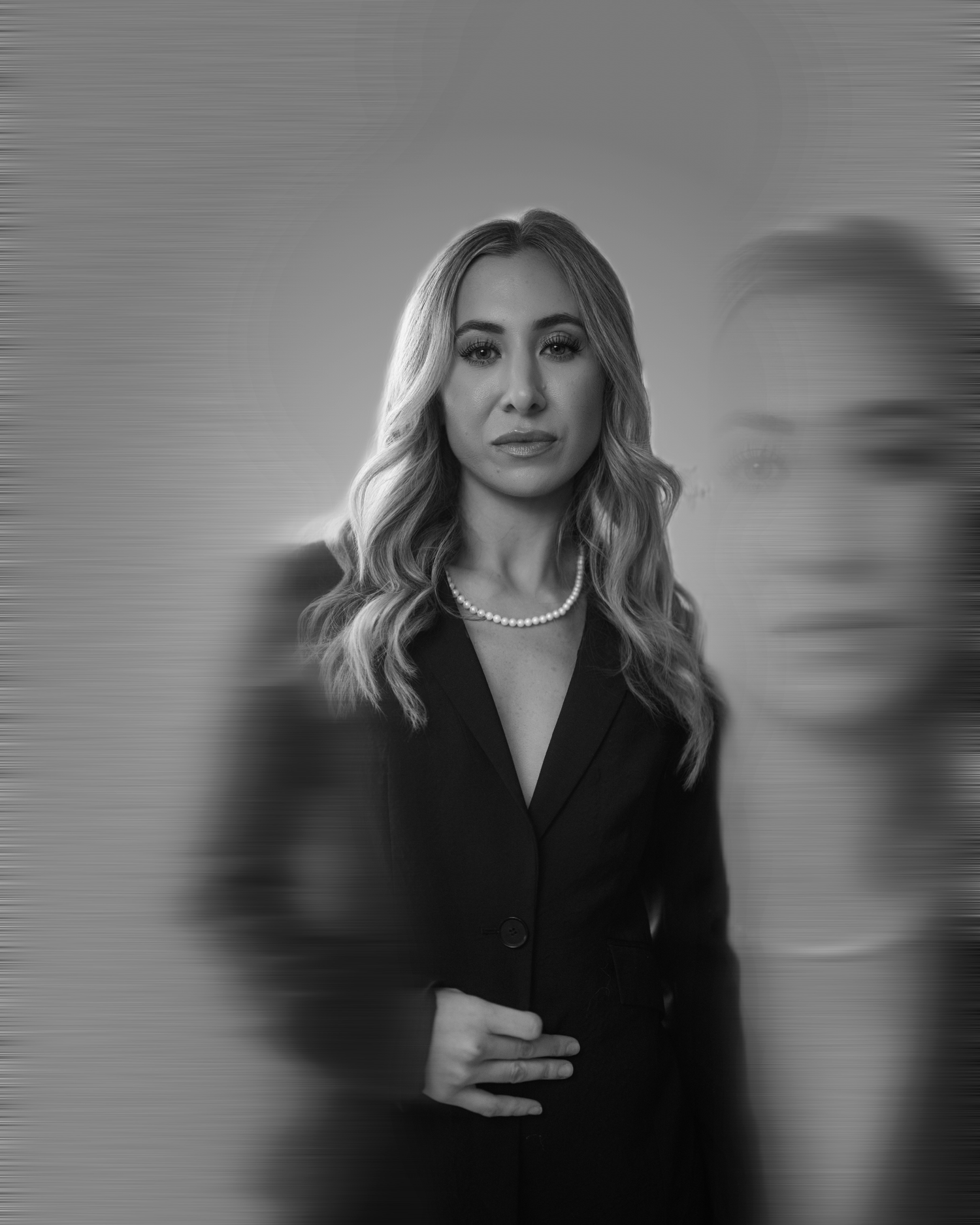 Black and white portrait series showing a person with blonde hair in various poses against a gray background.