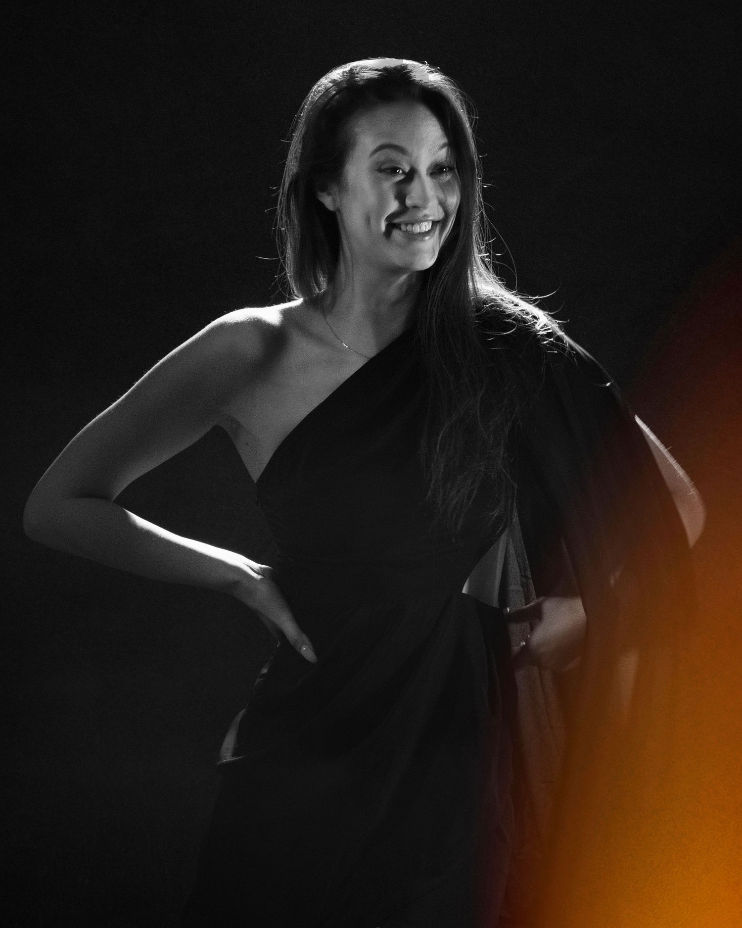 Dramatic black and white portrait series with warm orange gradient lighting effect adding artistic depth to the composition.