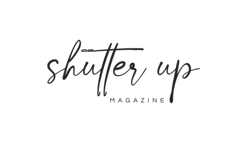 Shutter Up Magazine logo in elegant black script handwriting on white background.
