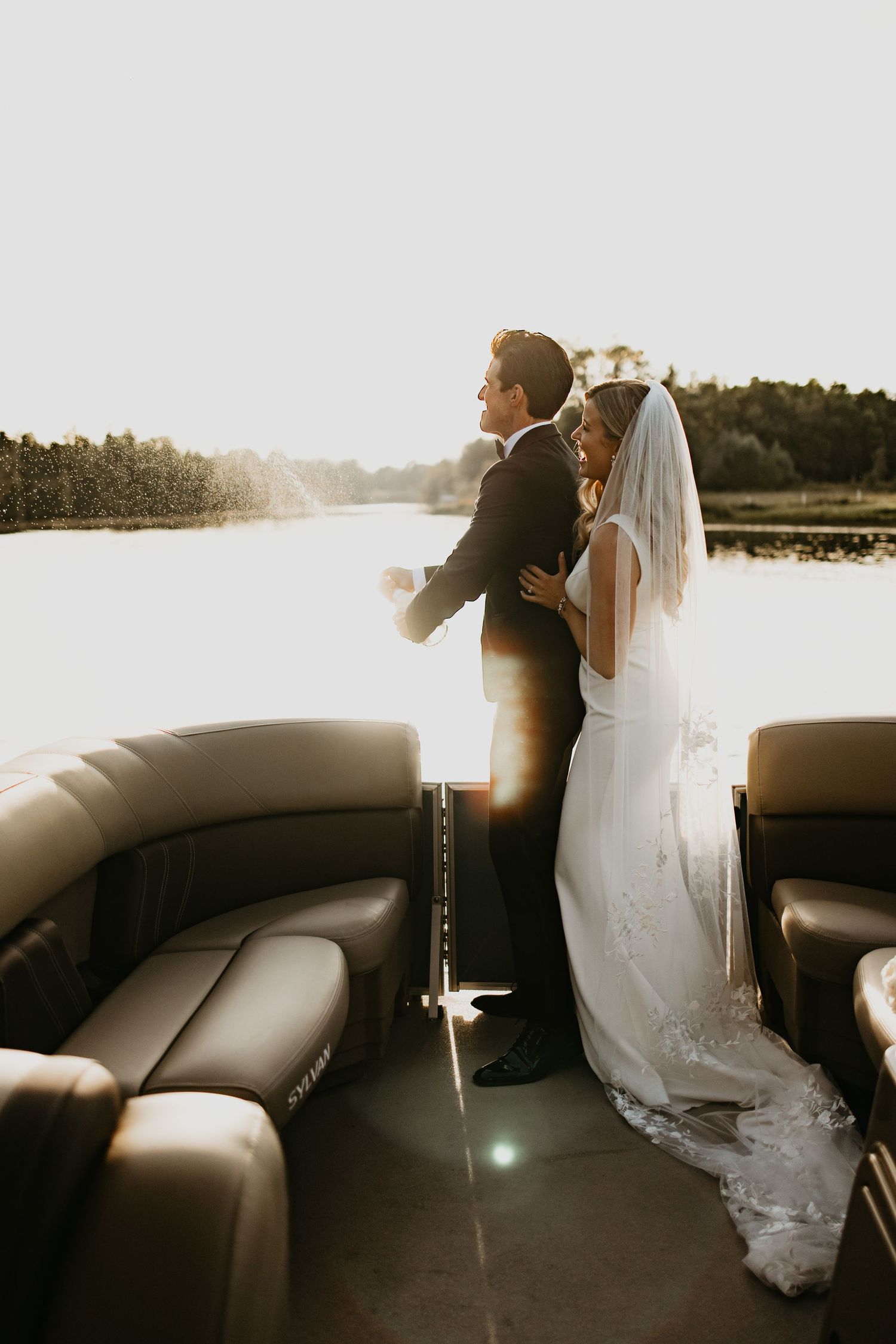 couple popping Champagne on wedding day