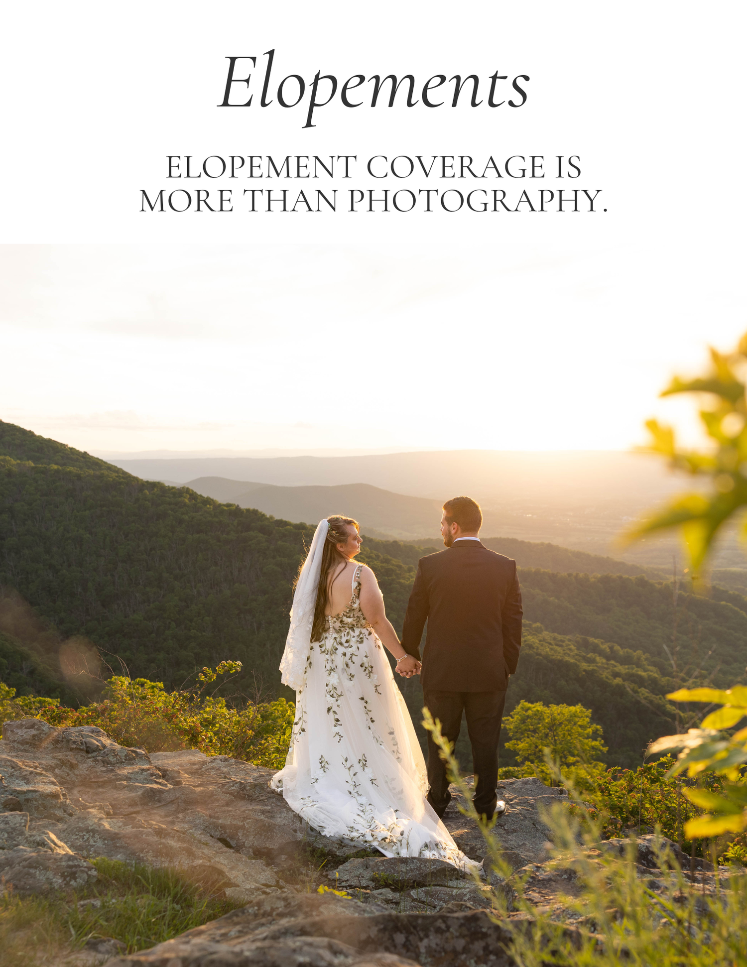 A bride and groom hold hands on a rocky mountain overlook at sunset, surrounded by lush green valleys below.