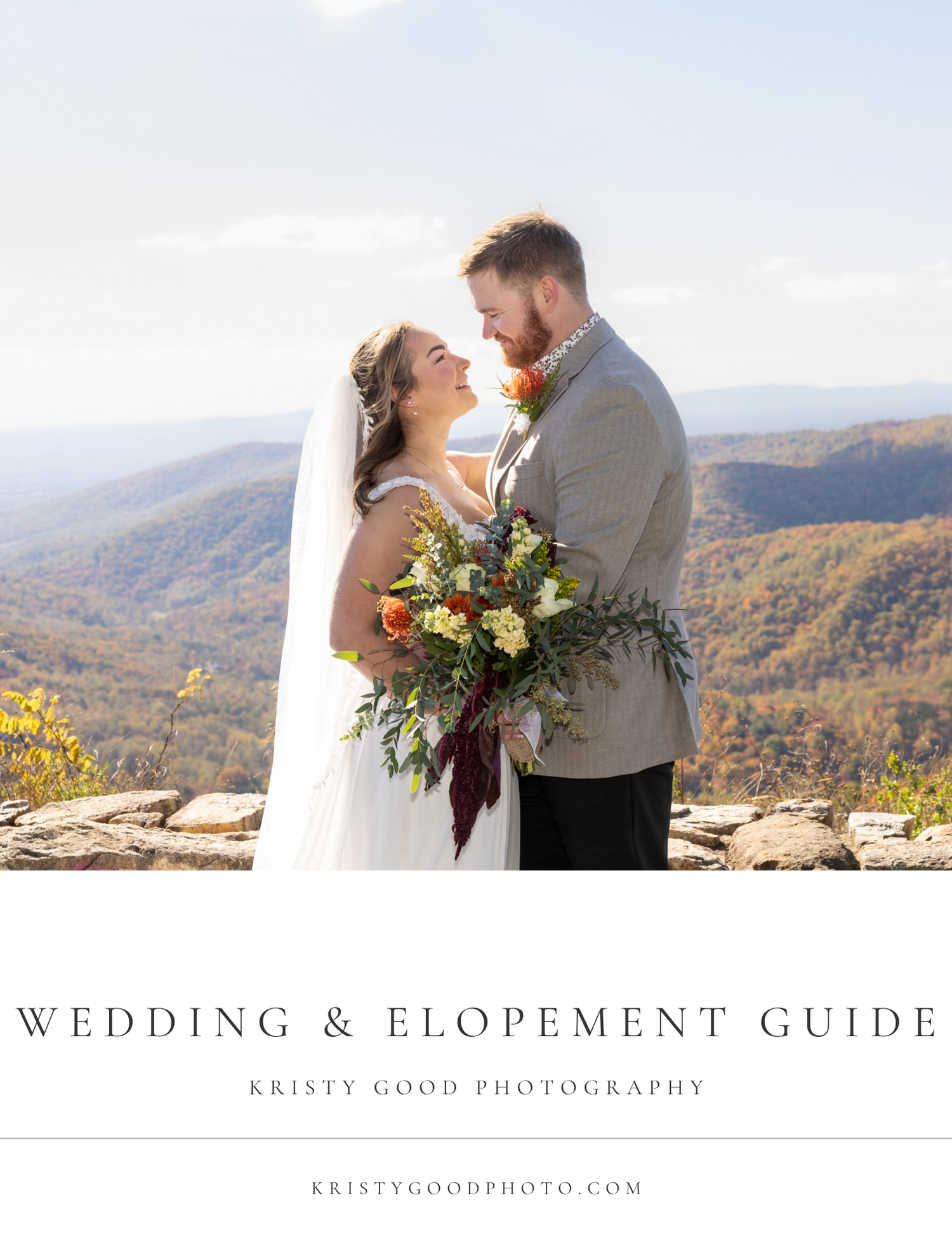 A couple shares an intimate moment on a mountain overlook during their elopement ceremony with fall foliage in background.