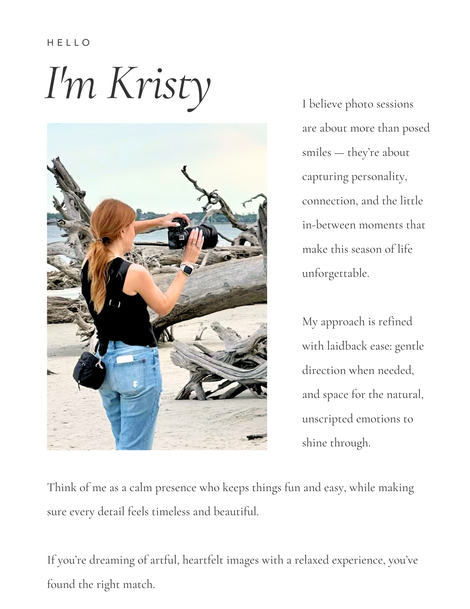A photographer in jeans and a black top takes photos while standing on rocky terrain outdoors.
