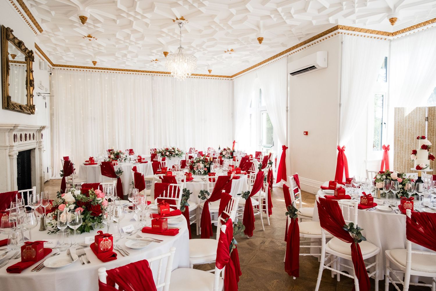 Wedding reception room decorated with bold red décor at Highley Manor.
