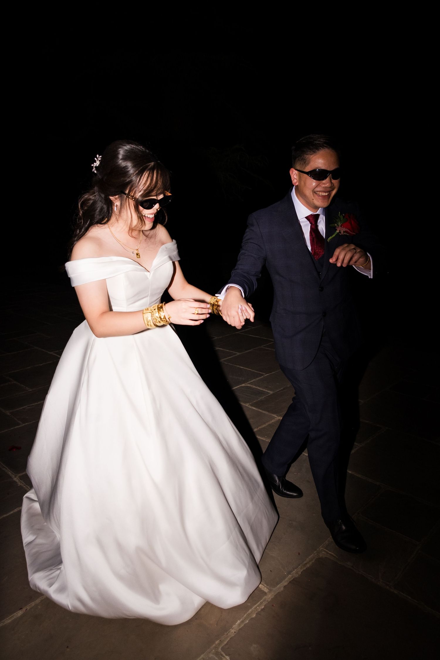 Flash wedding portraits of bride and groom outside Highley Manor at night.