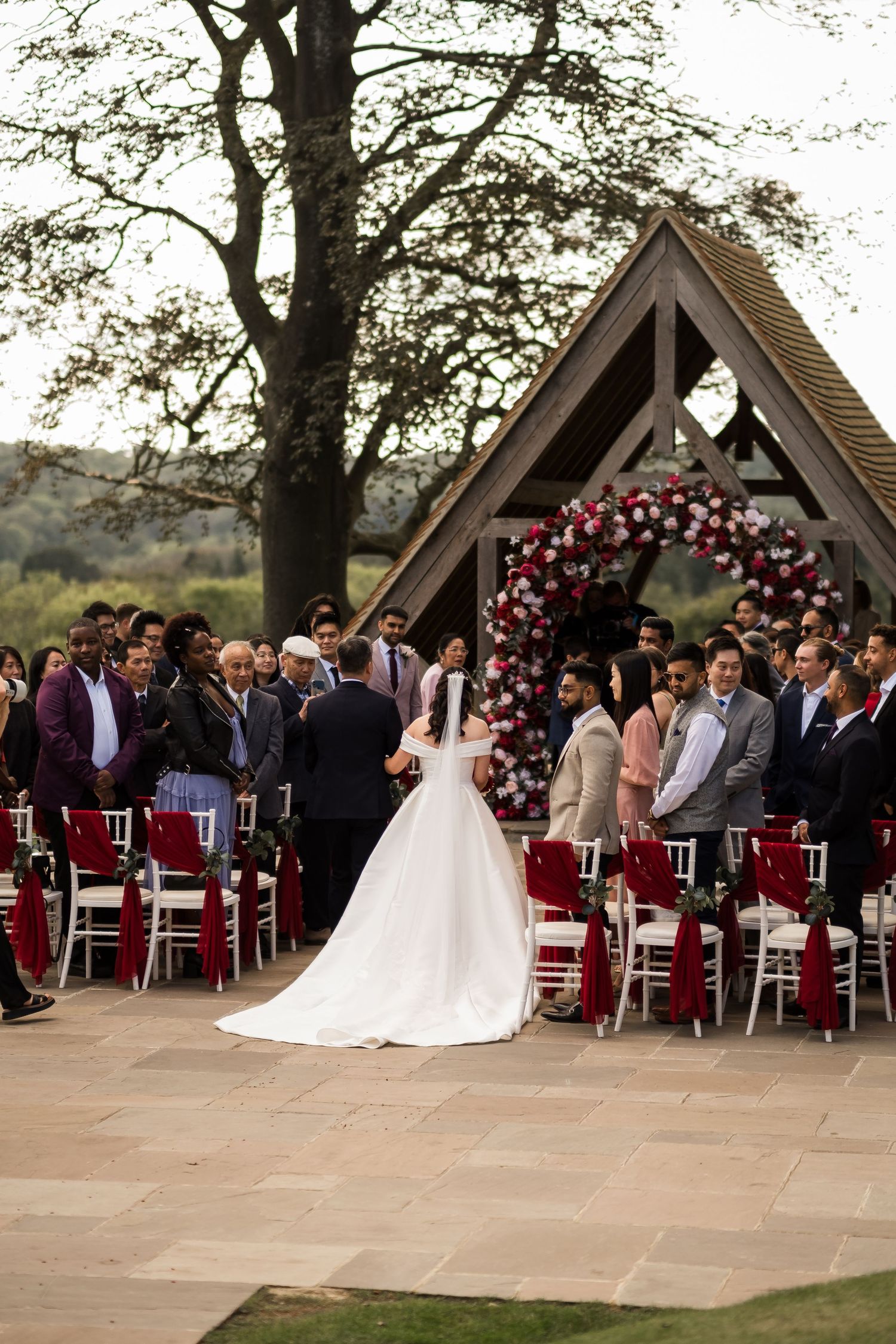 Bride walking down the aisle during a romantic outdoor ceremony at Highley Manor.