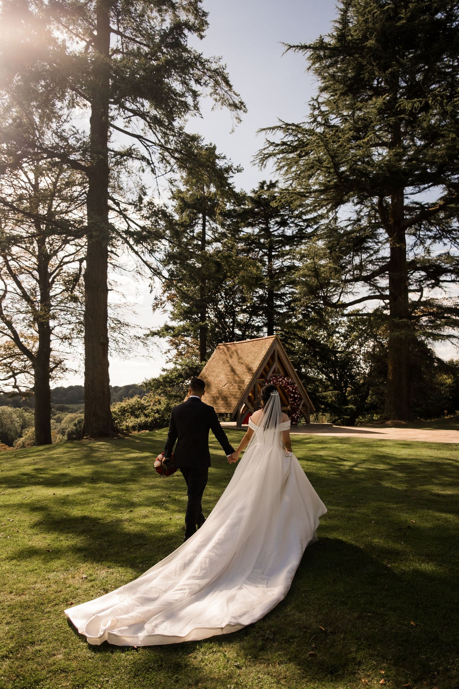 Bride and groom portraits in the gardens of Highley Manor wedding venue in Sussex.