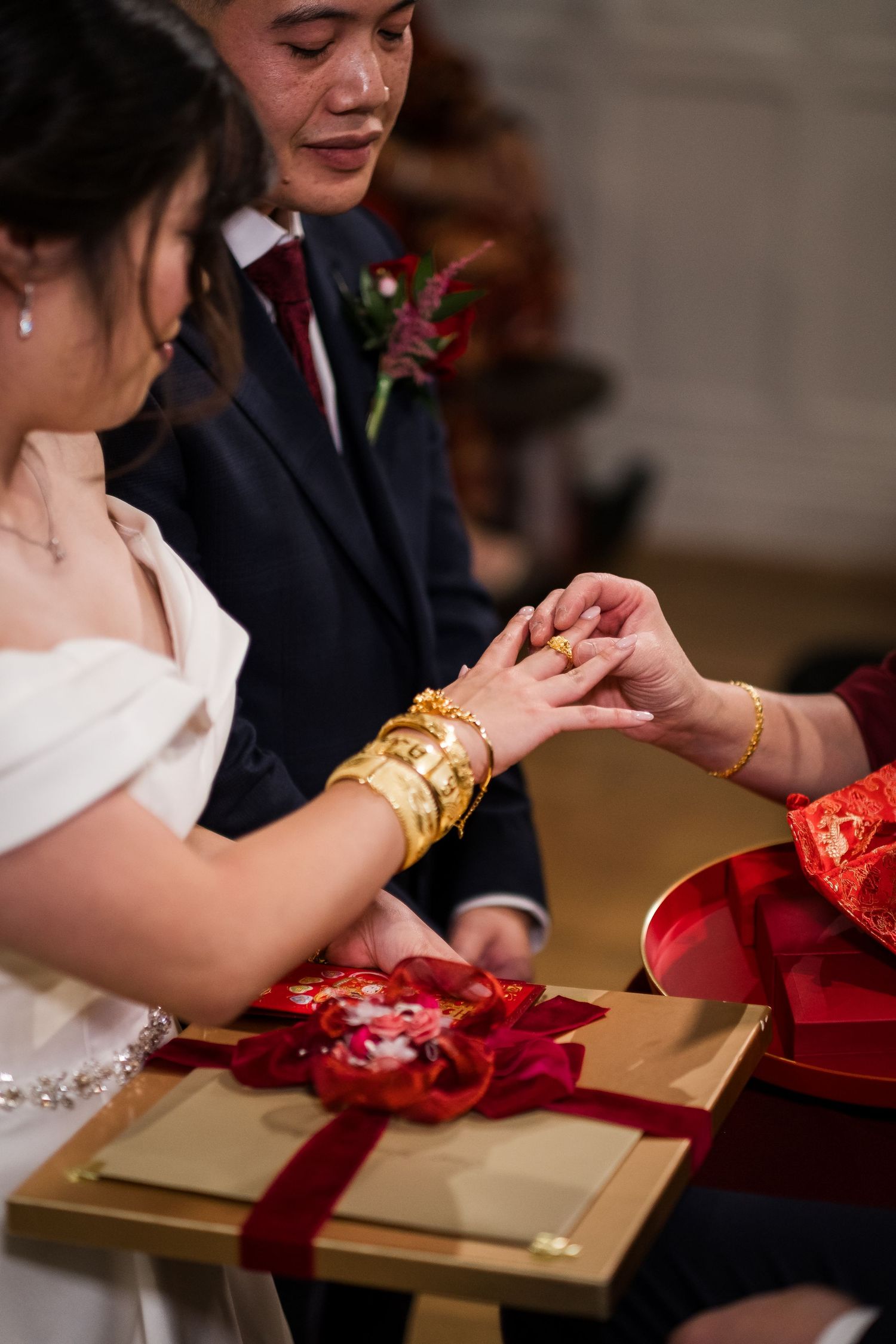 A traditional Chinese wedding tea ceremony shows close-up shots of hands exchanging ceremonial items.
