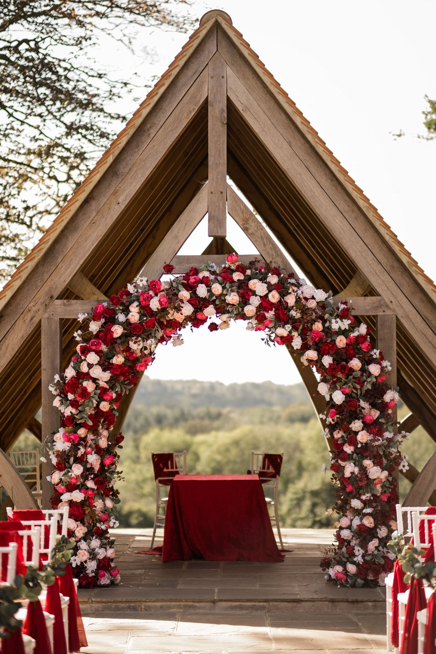 Outdoor wedding ceremony structure at Highley Manor overlooking the Sussex hills.
