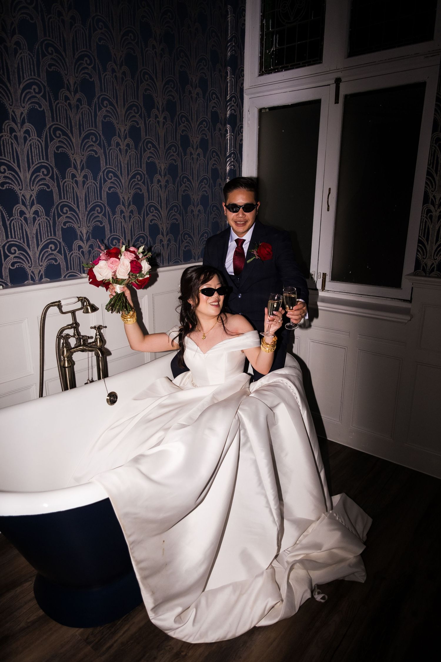 Fun honeymoon suite bathtub photos during evening wedding celebrations.