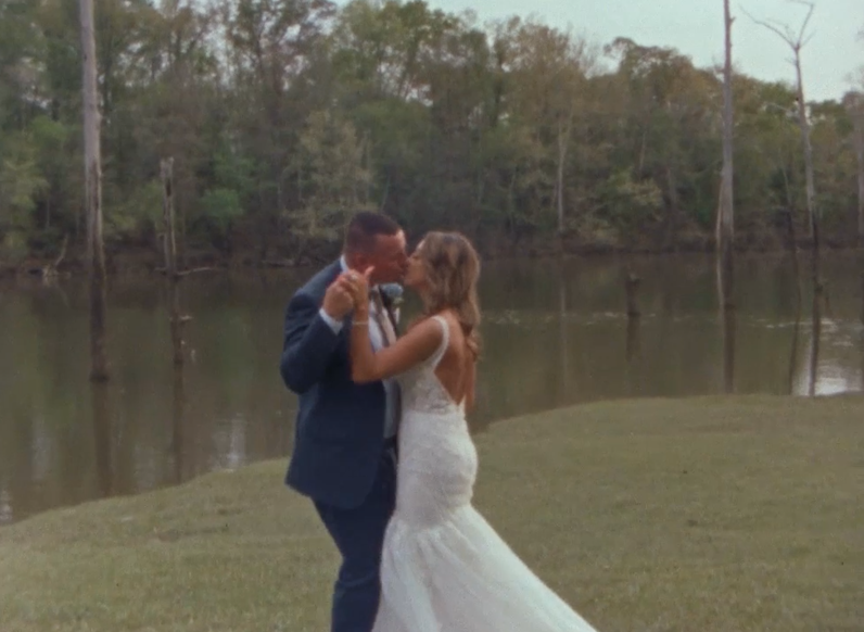 Still from Super 8 film of couple dancing in an outdoor setting with trees in the background in Millbrook, Alabama.