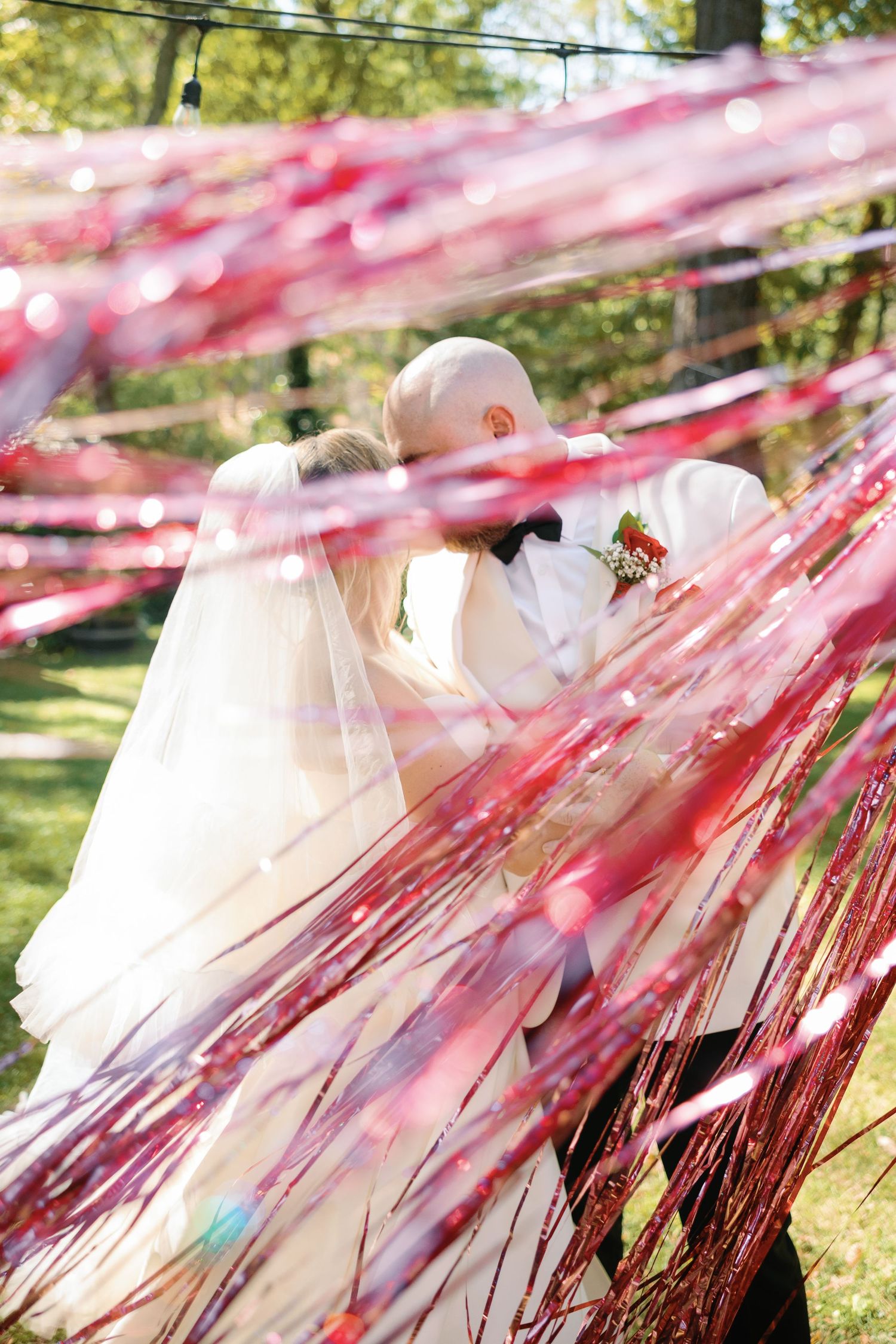 Wedding scene with flowing pink streamers creating a dreamy outdoor atmosphere at Pythian House Cottage in Santa Rosa, CA.