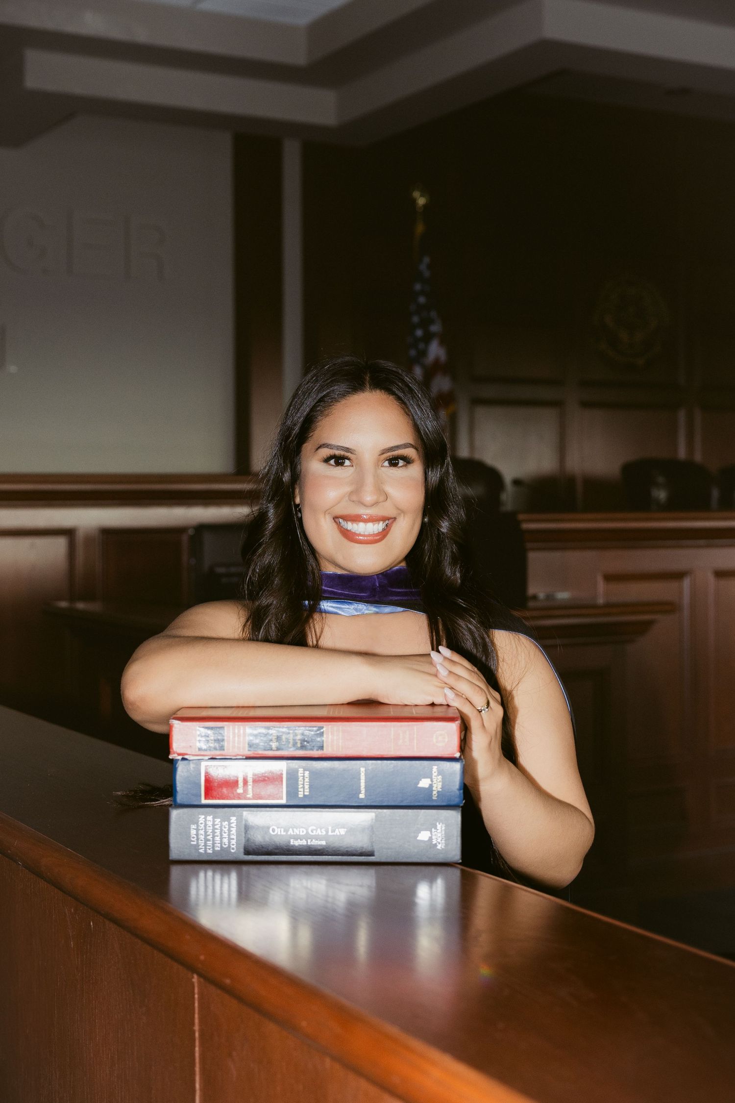 A split sequence of photos shows someone peeking playfully over textbooks on a dark wooden table.