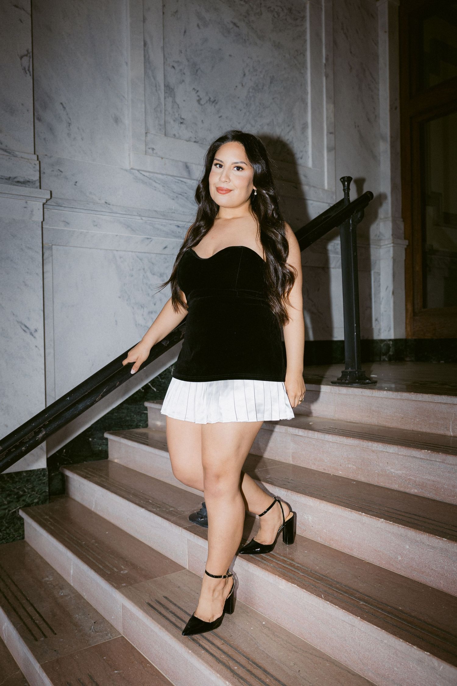 A sequence of film photos showing someone ascending stairs in black heels and a white dress.