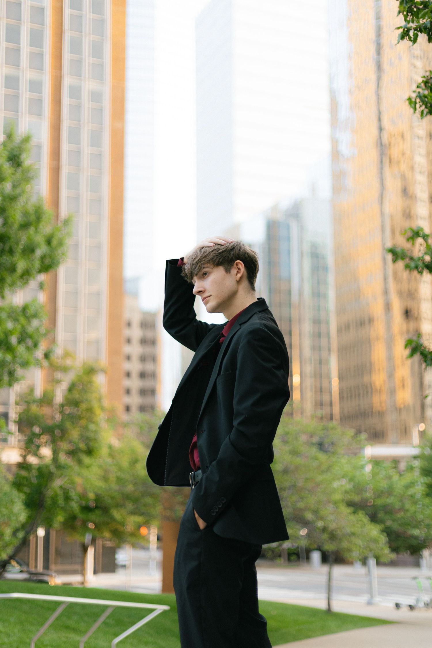 A collection of fashion portraits showing a person in formal wear posing against a modern building exterior.