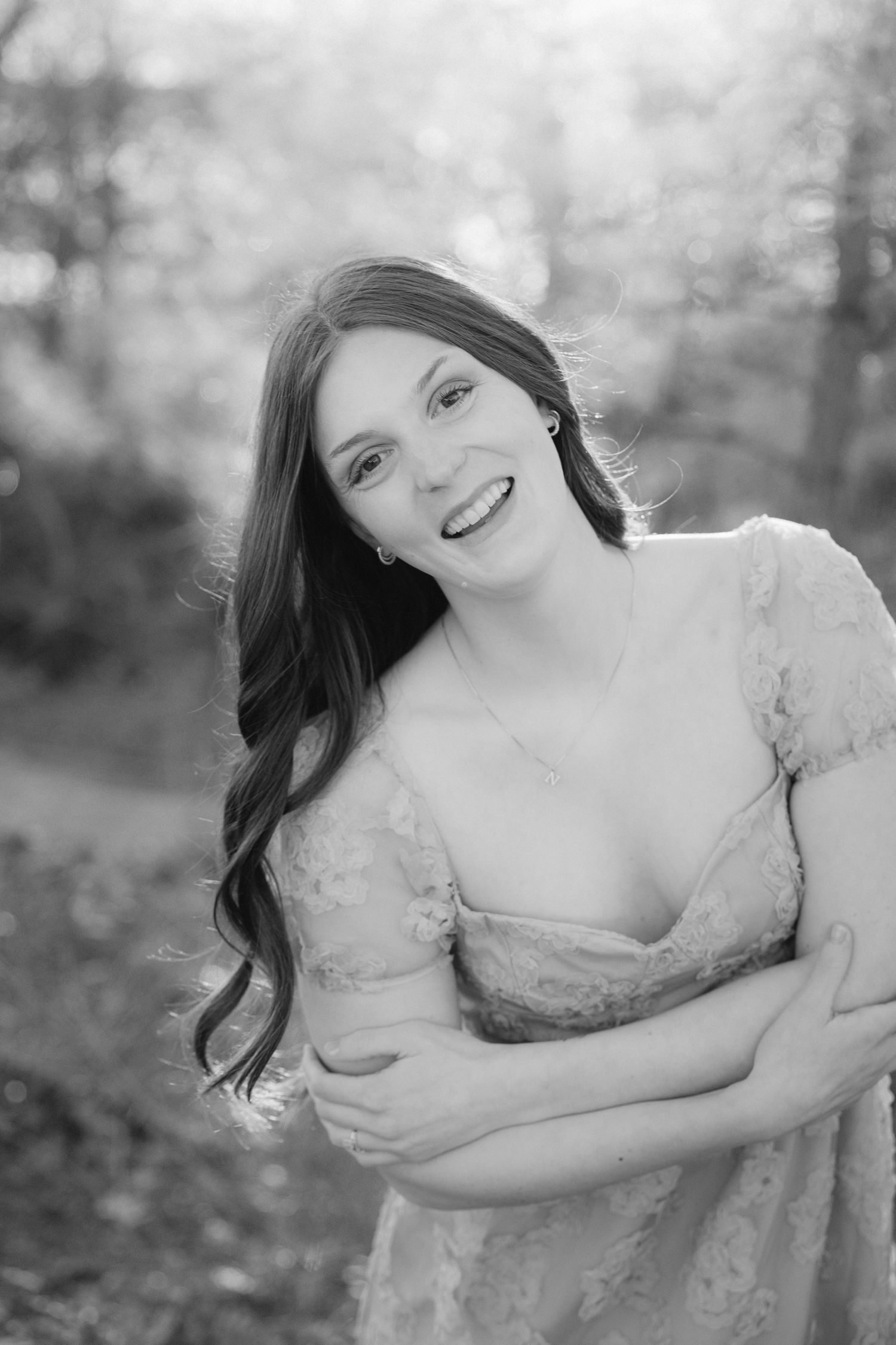 Artistic black and white photo series showing a woman in a lace dress posing gracefully in an outdoor setting.