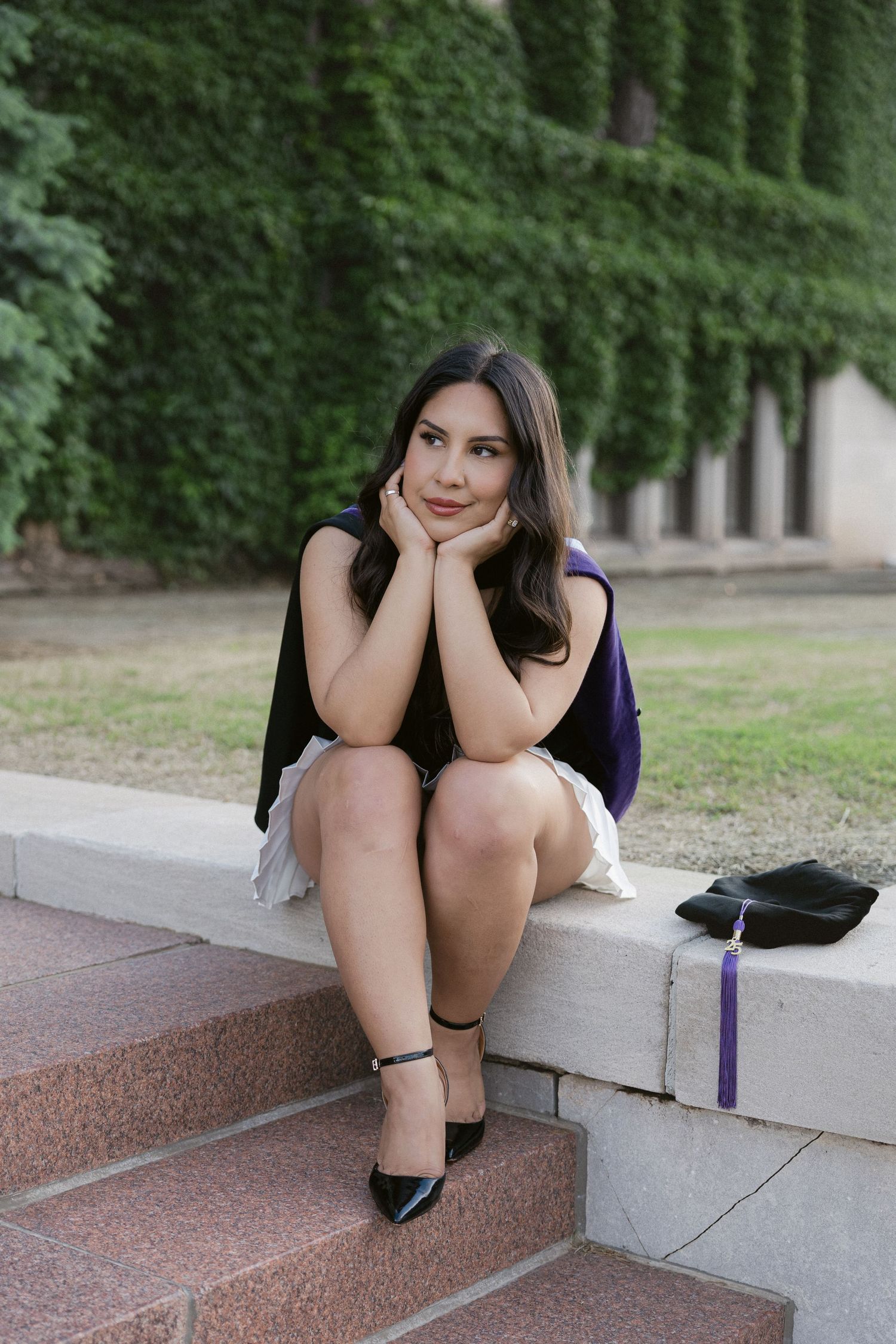 A woman in a dark dress sits casually on concrete steps in a series of connected artistic outdoor portraits.