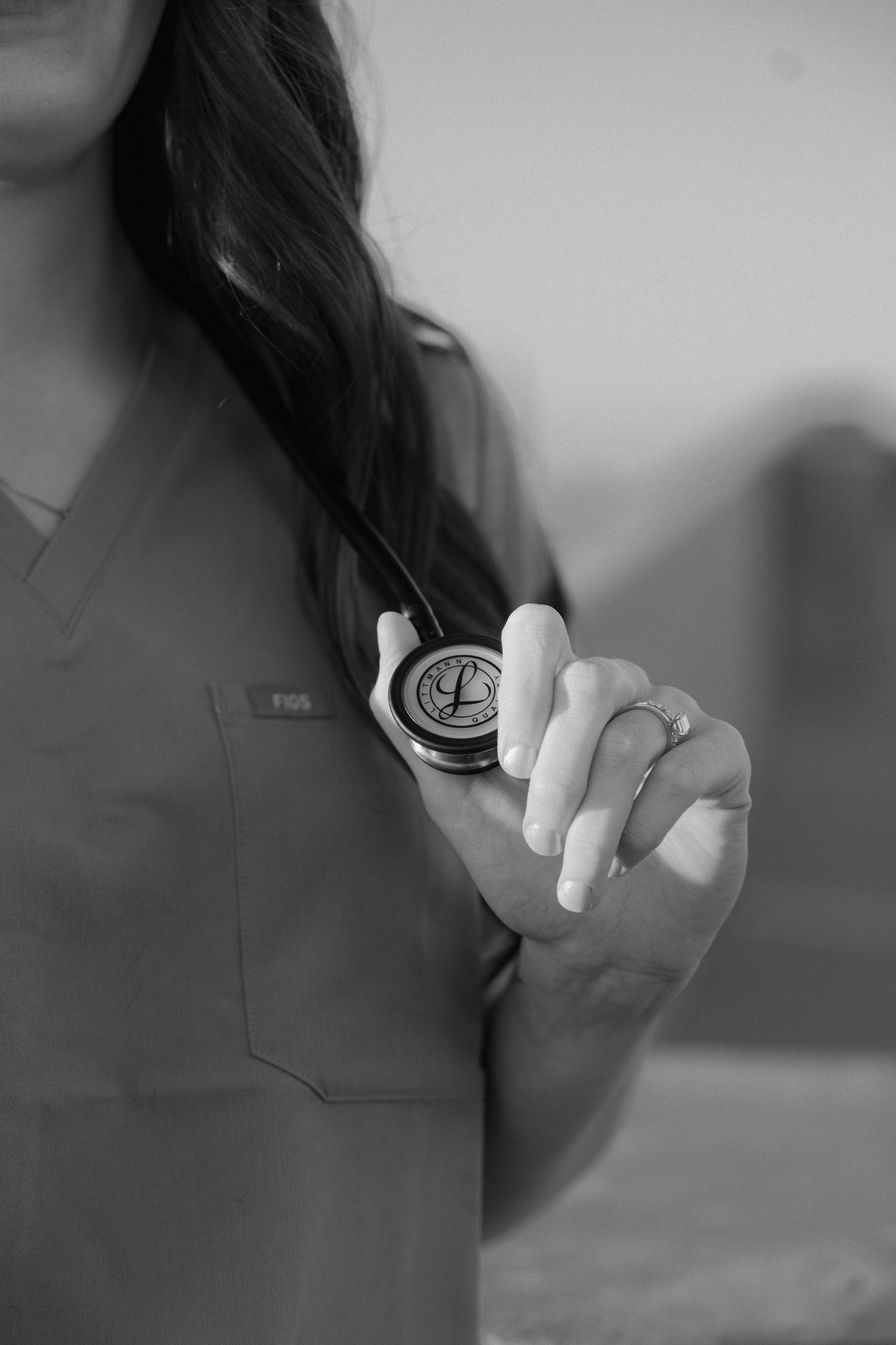 Series of black and white close-up shots showing a medical professional holding a syringe against a blurred background.