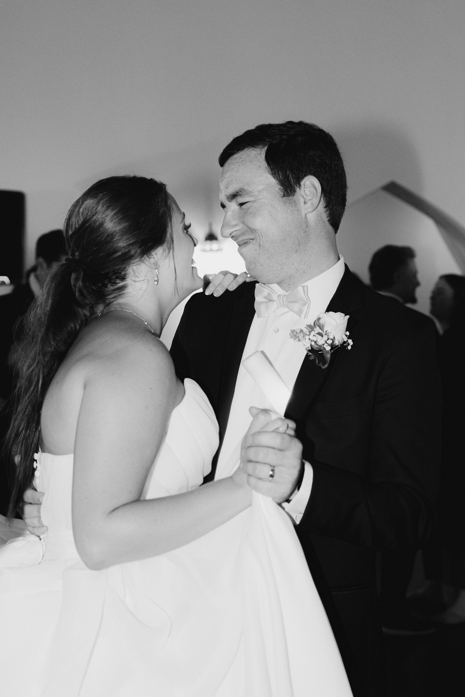Black and white intimate moment of newlyweds sharing their first dance.