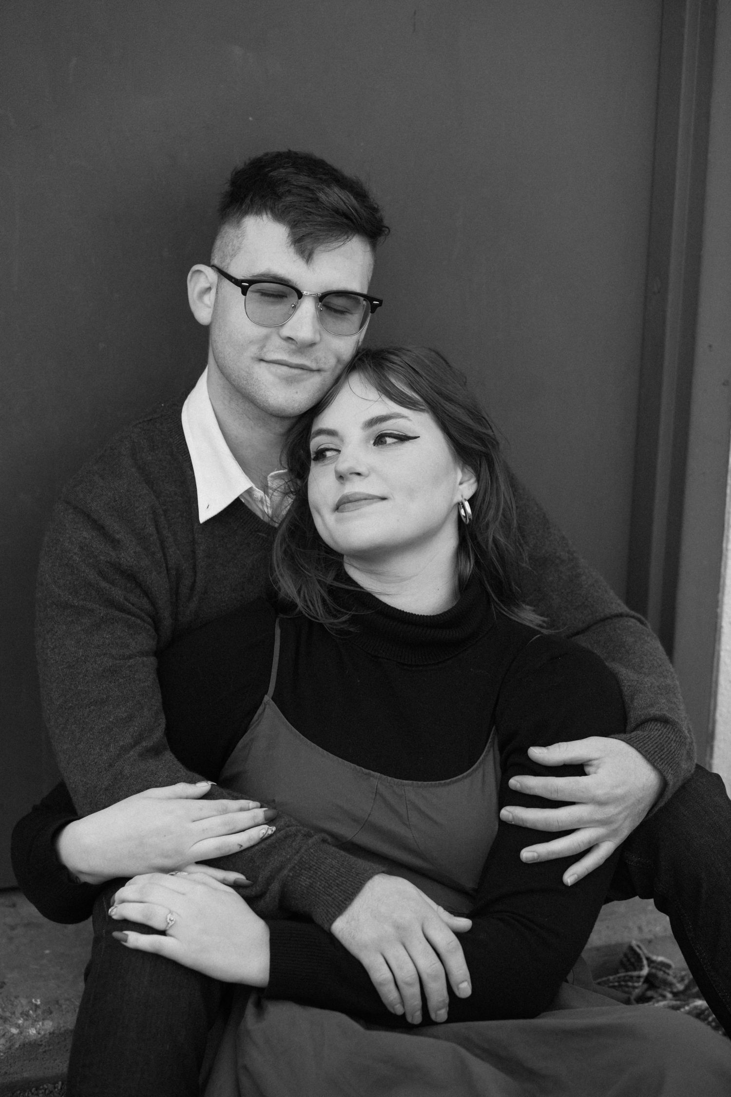A romantic black and white photo series showing a couple embracing and sharing intimate moments together.