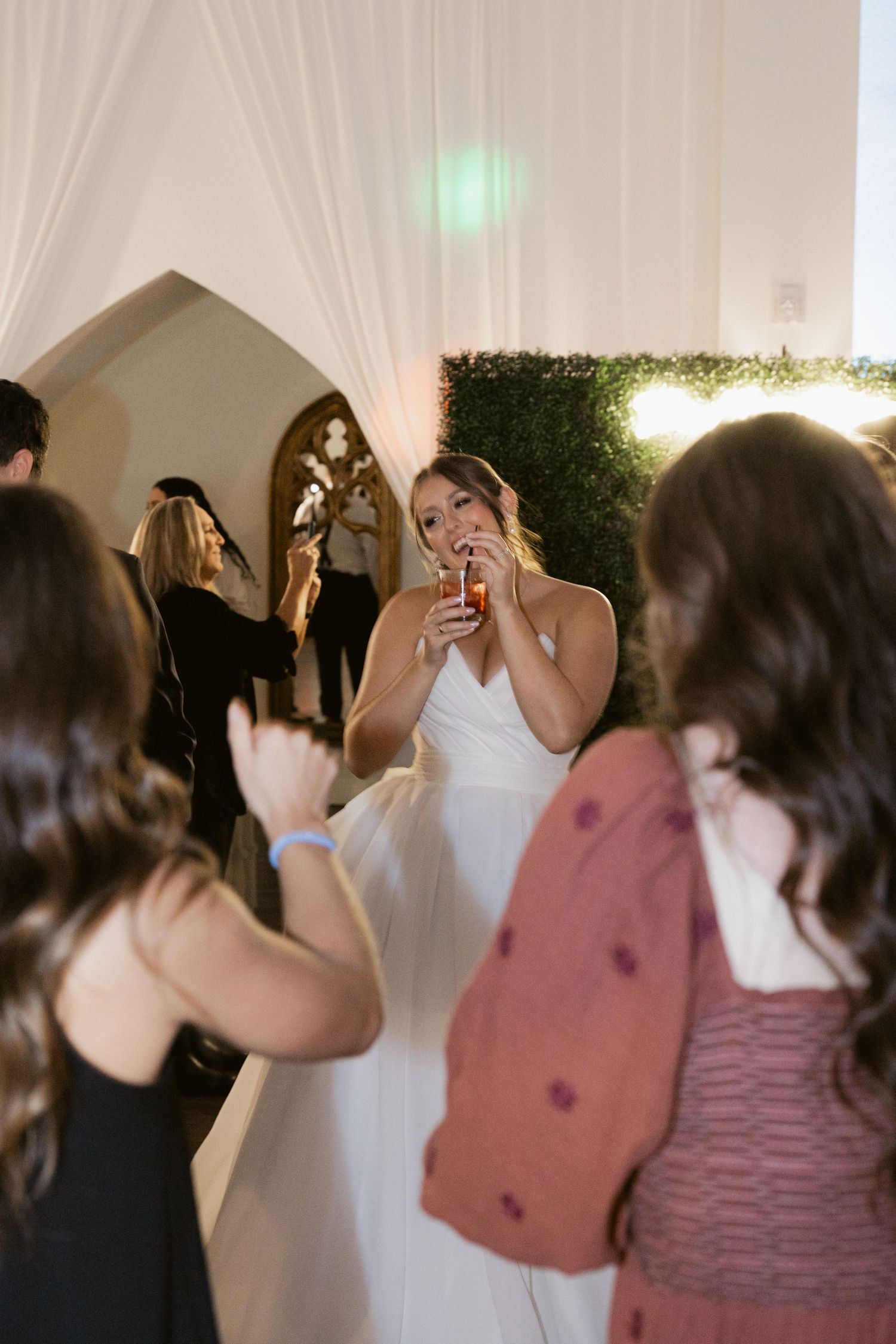Wedding guests react joyfully during reception celebrations.