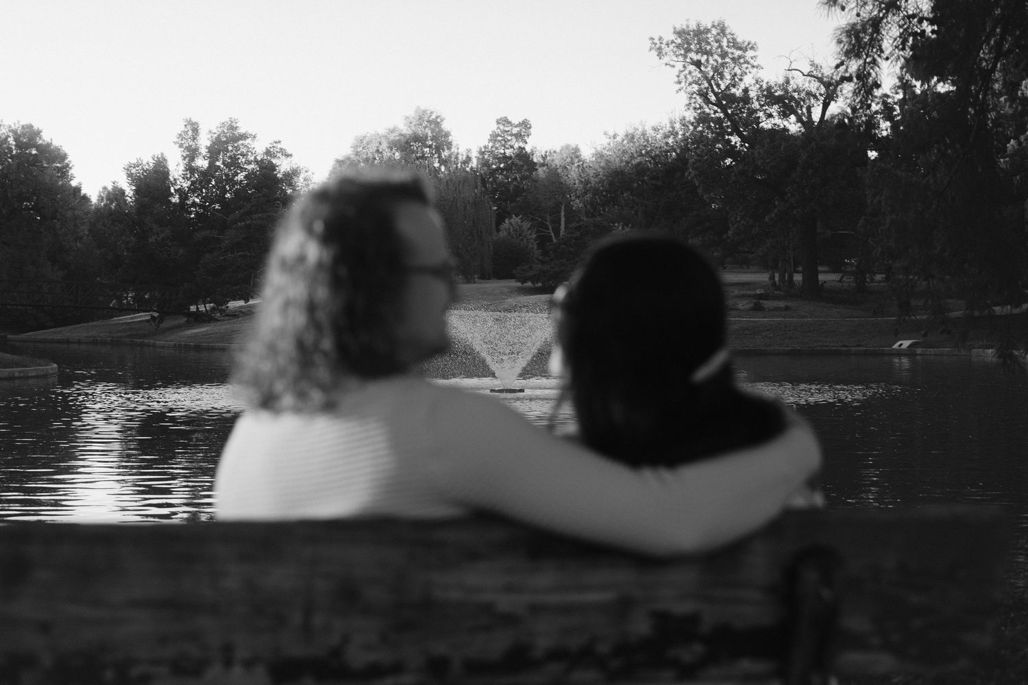 A series of black and white photos showing silhouettes against a lake or pond at sunset.