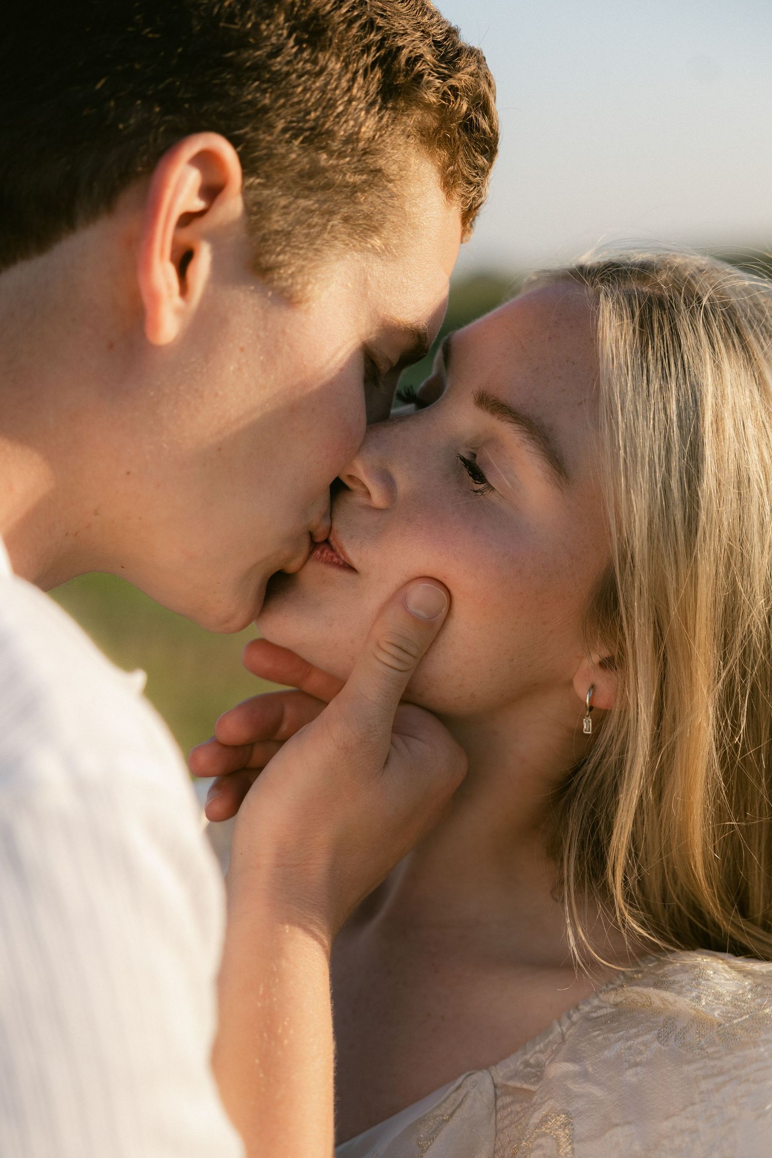 A romantic couple sharing tender kisses in a series of intimate close-up photos with soft lighting and blurred backgrounds.